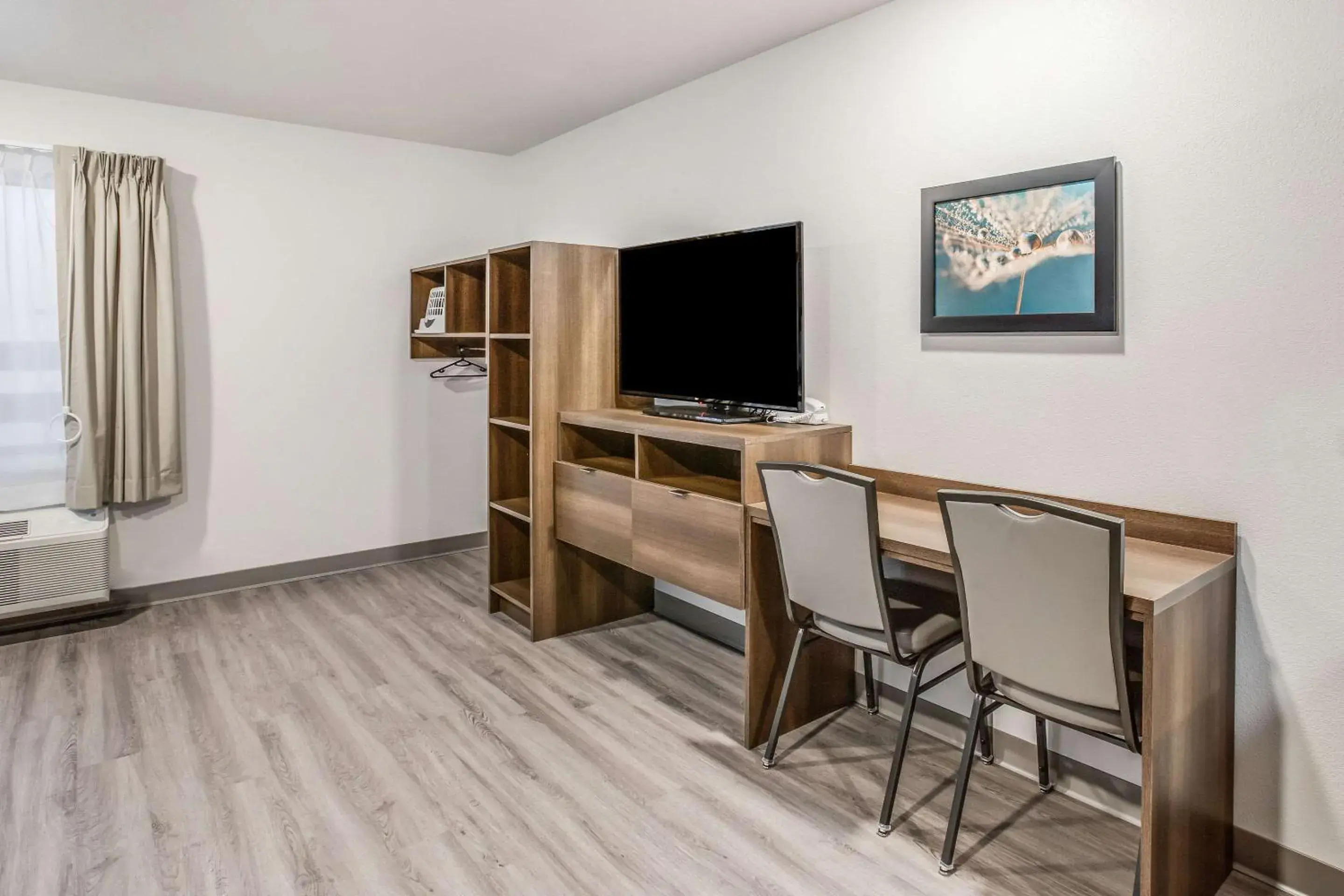 Photo of the whole room, TV/Entertainment Center in WoodSpring Suites Detroit Farmington Hills