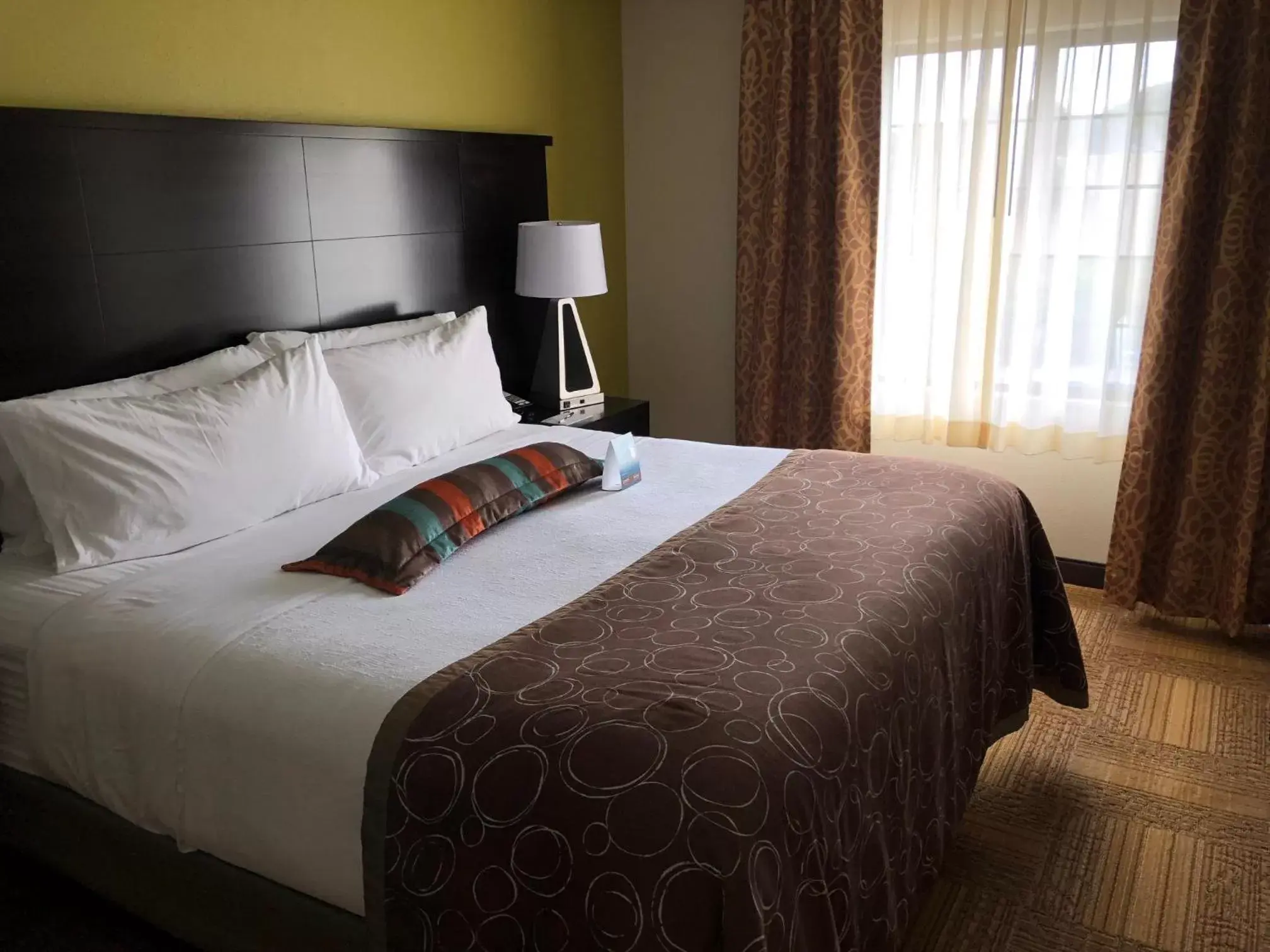 Bed in Staybridge Suites Grand Rapids-Kentwood, an IHG Hotel