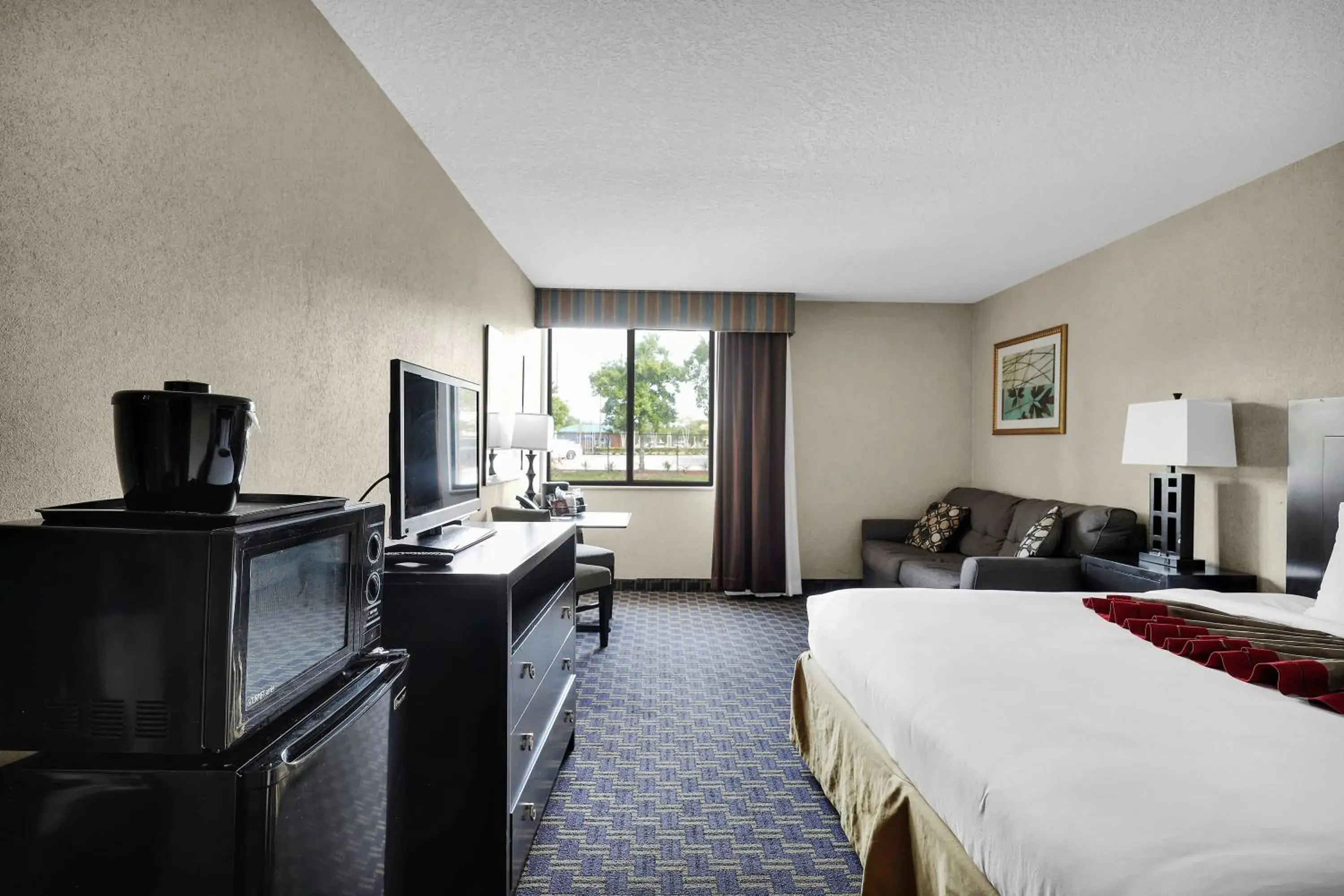 Bed in Ramada by Wyndham Jacksonville I-95 by Butler Blvd