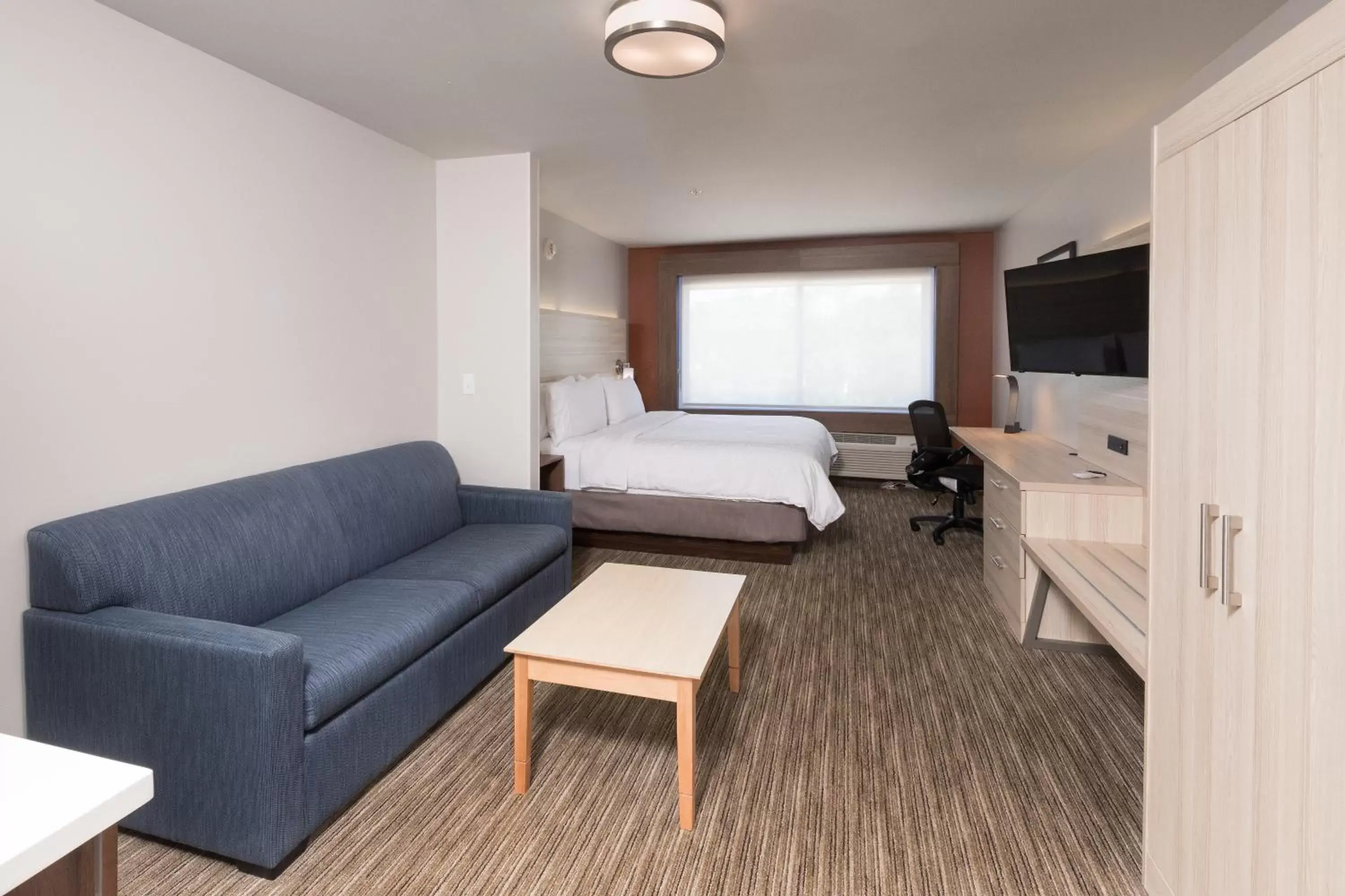 Bed, Seating Area in Holiday Inn Express & Suites - Michigan City, an IHG Hotel