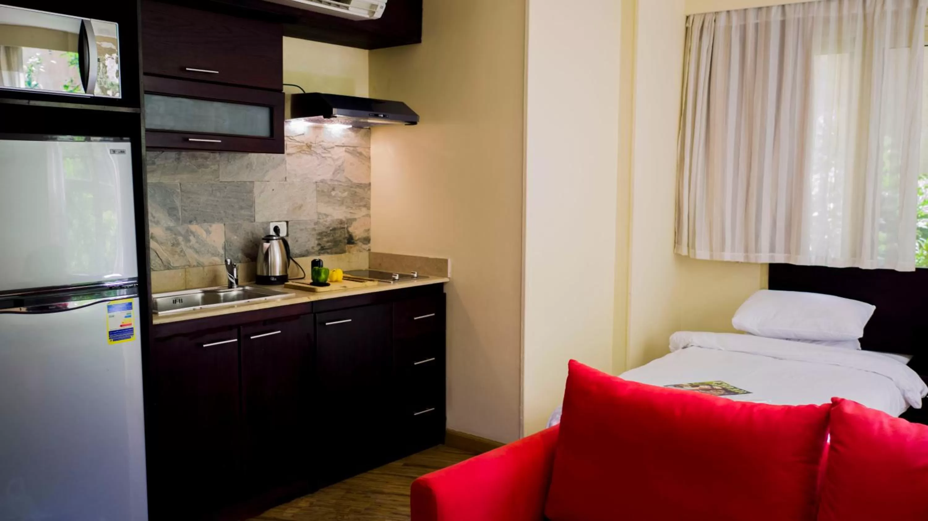Kitchen or kitchenette, Bed in NewCity Hotel & Suites