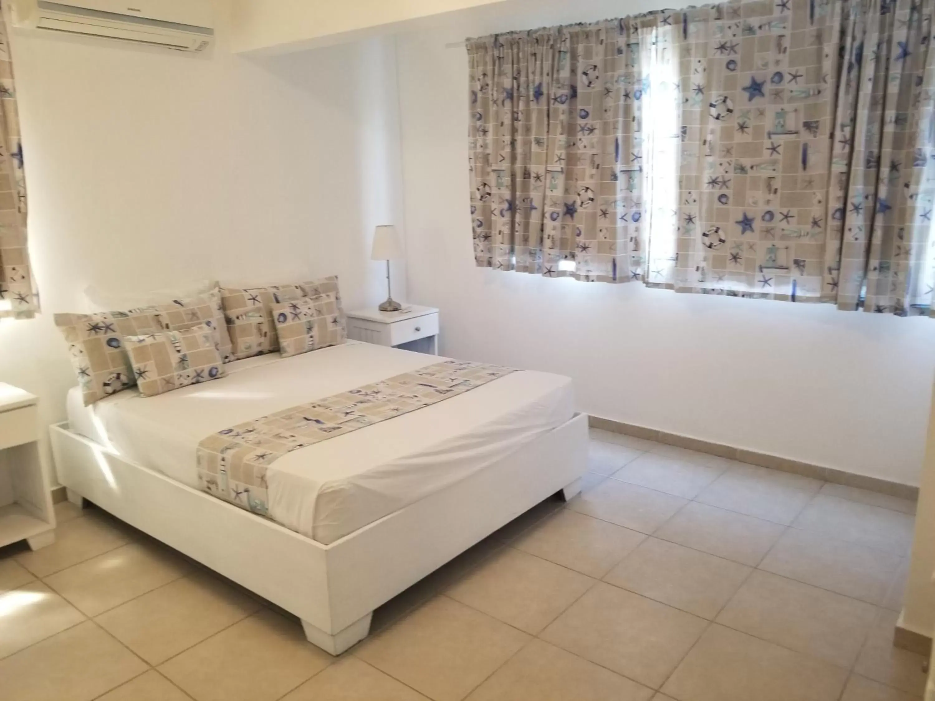 Bed in Karimar Beach Condo Hotel