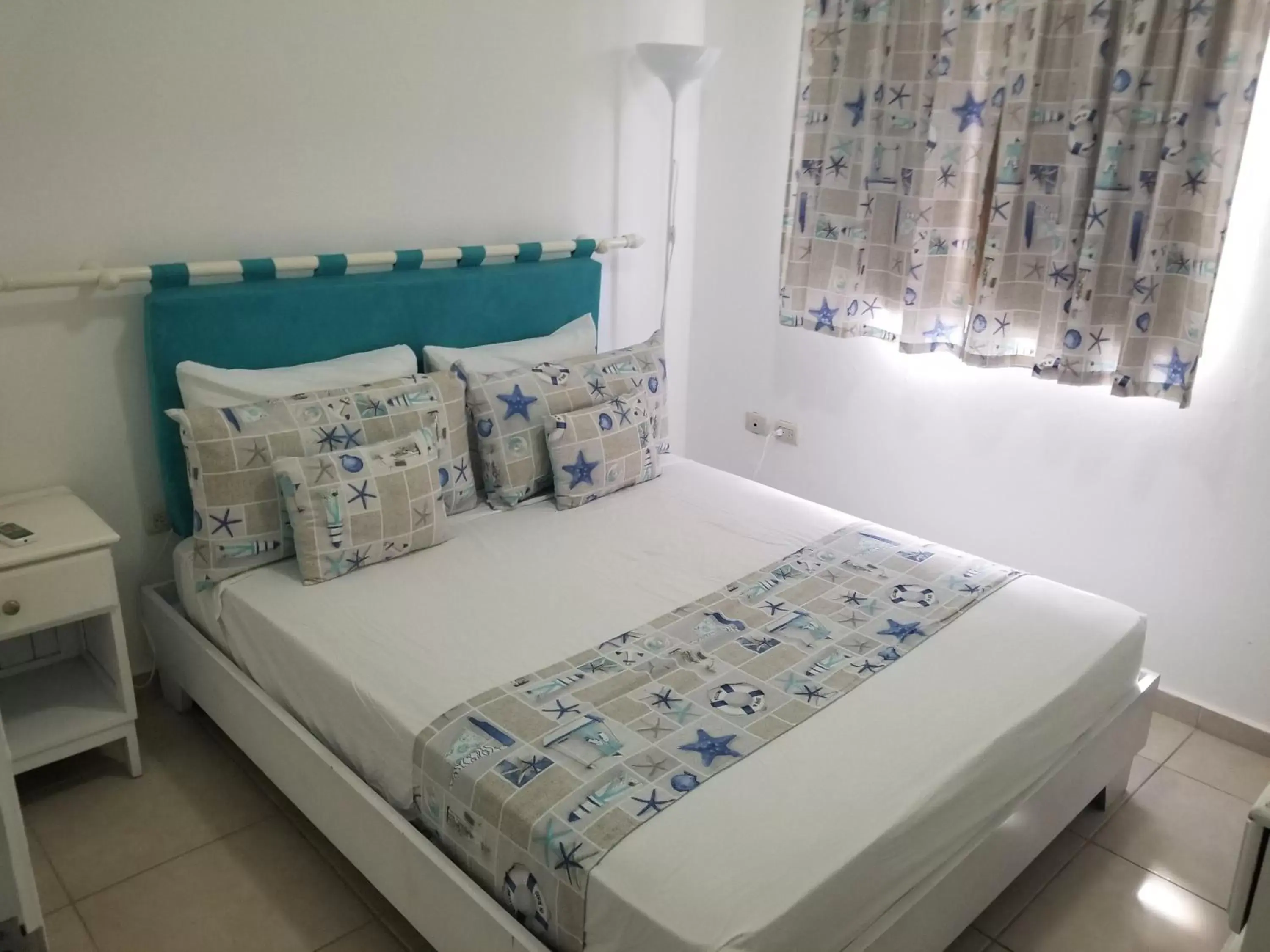 Bed in Karimar Beach Condo Hotel