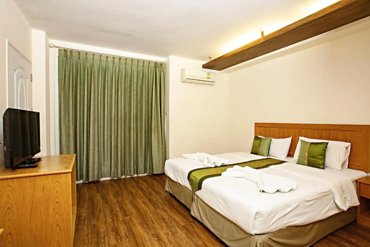 Bed in TM Land Hotel