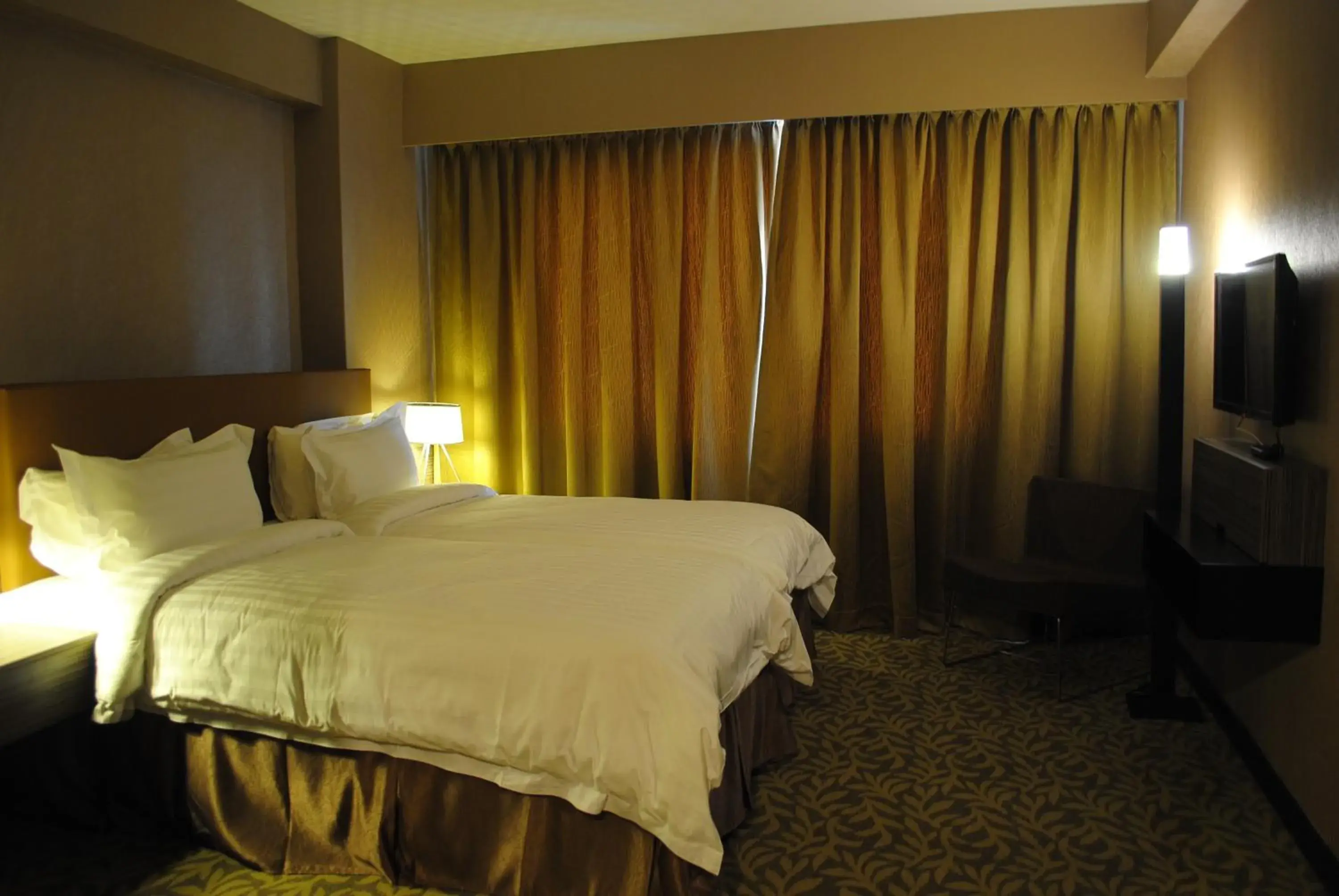 Bed in Grand Alora Hotel