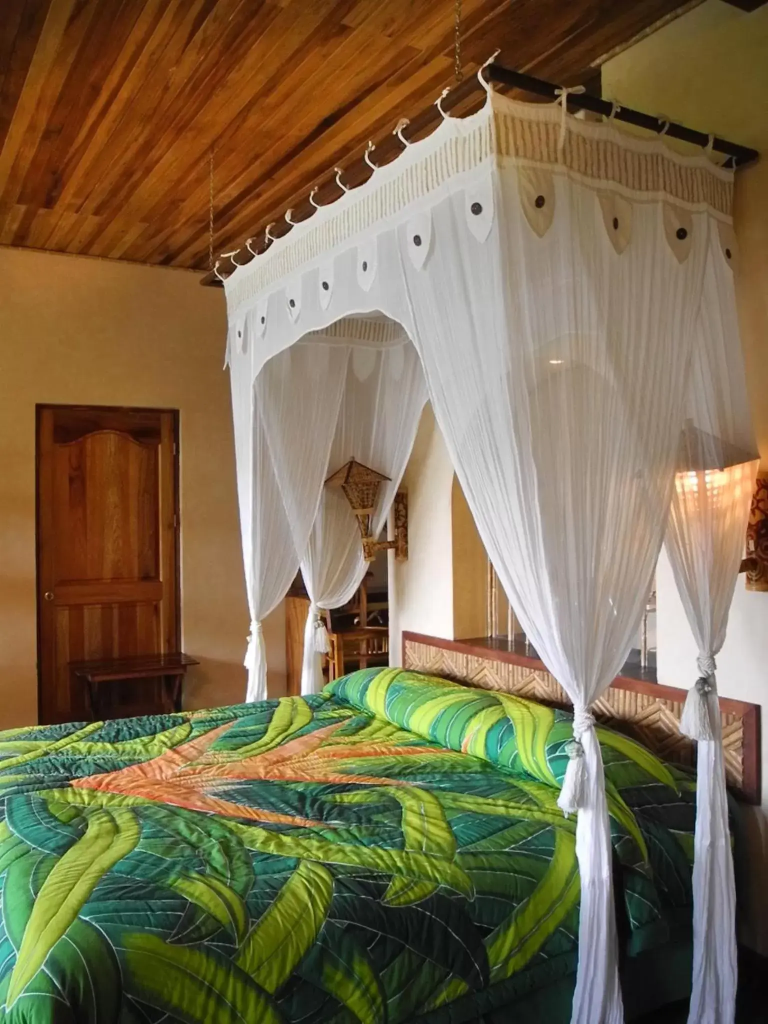 Bed in Lost Iguana Resort and Spa