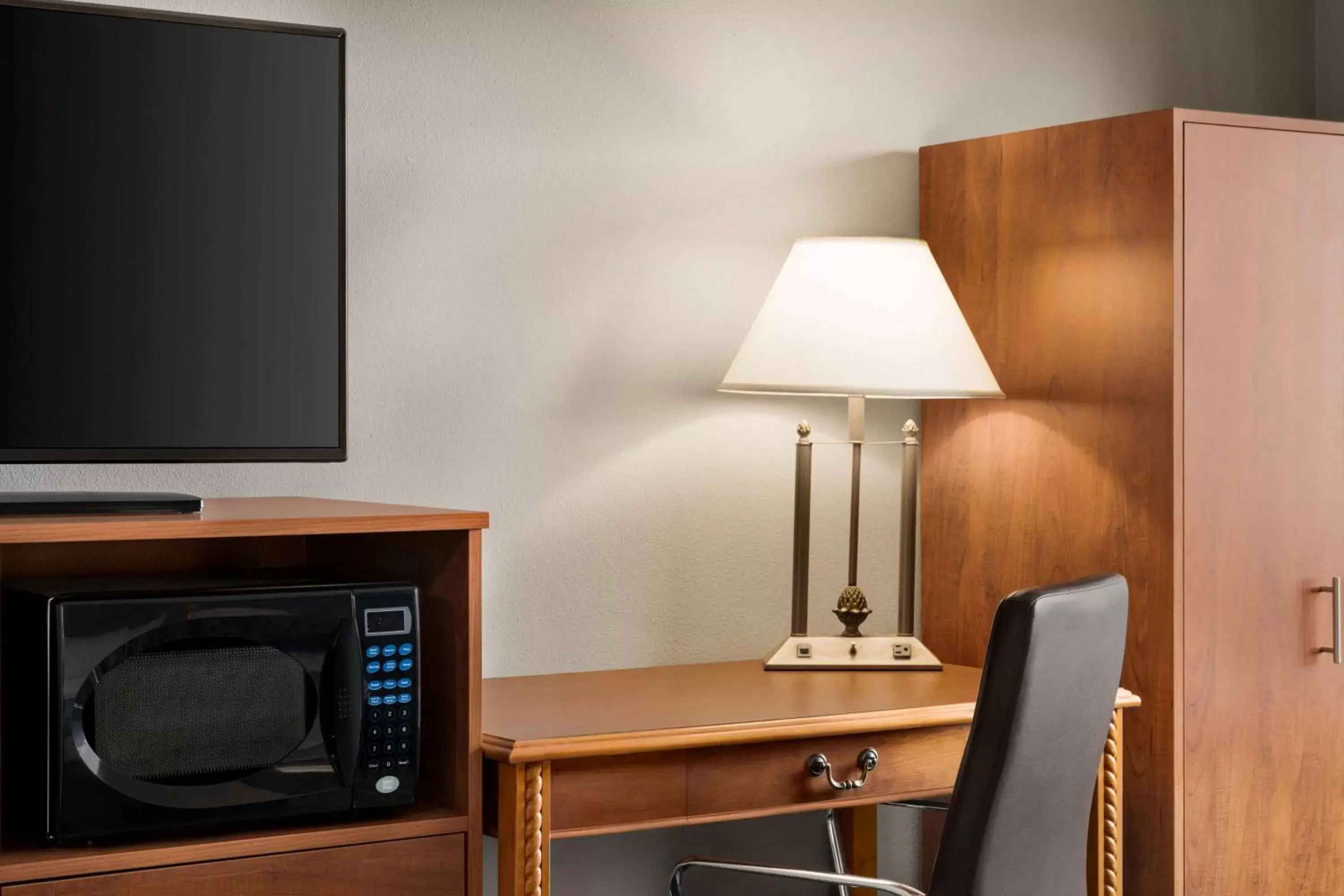 Photo of the whole room, TV/Entertainment Center in AmericInn by Wyndham Laramie Near University of Wyoming