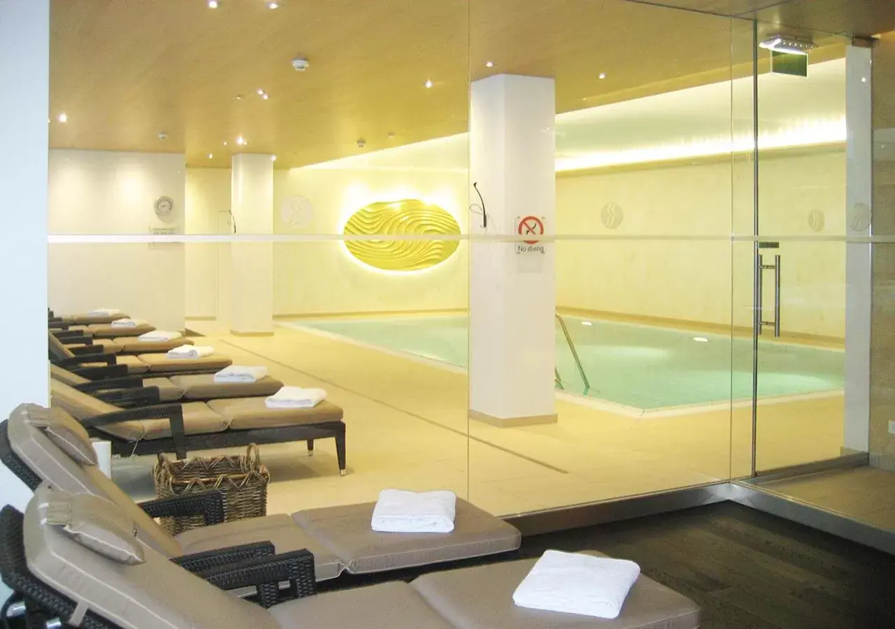 Swimming pool, Bathroom in Ramada Nuernberg Parkhotel