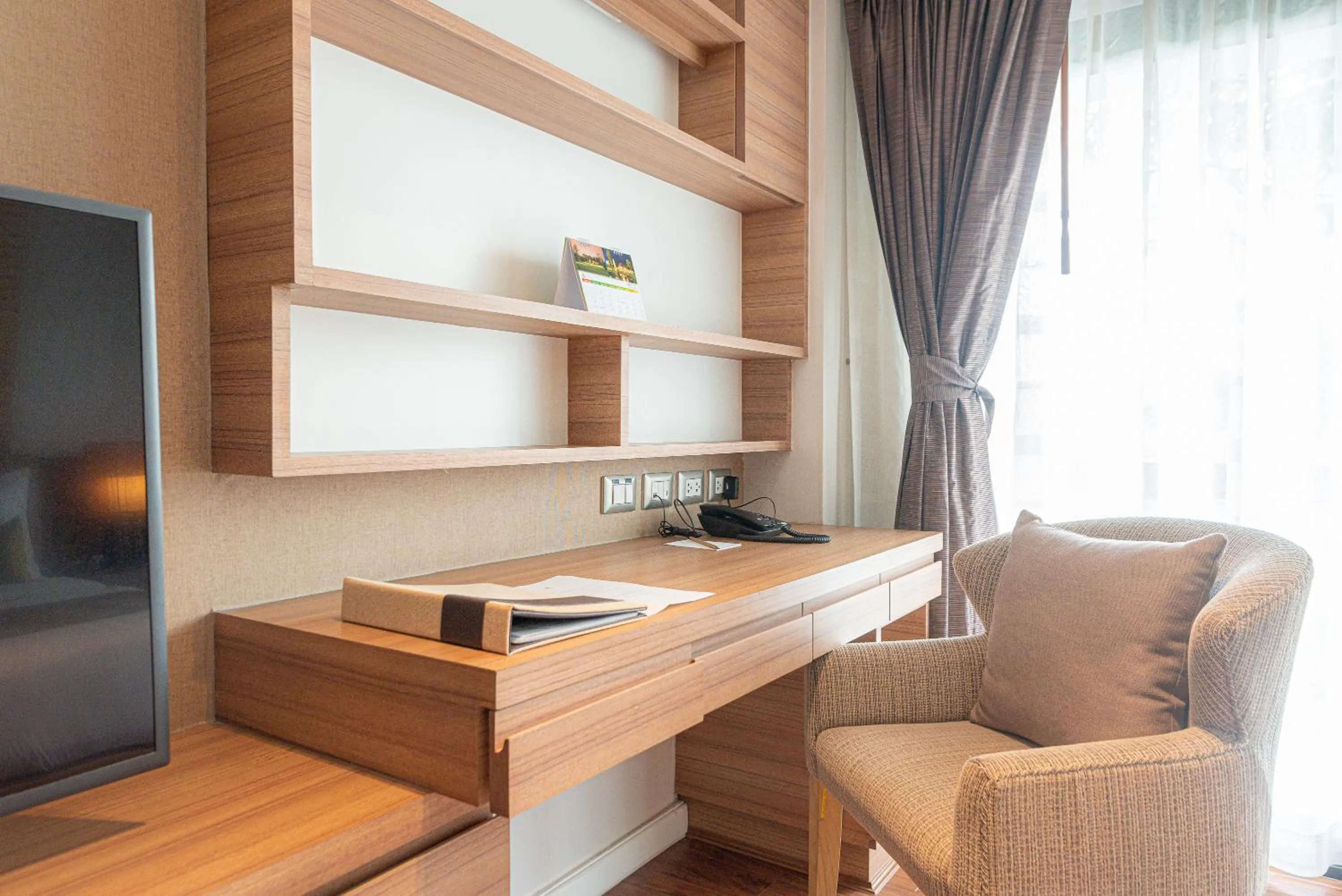 Living room in Summit Windmill Golf Suite Hotel at Suvarnabhumi