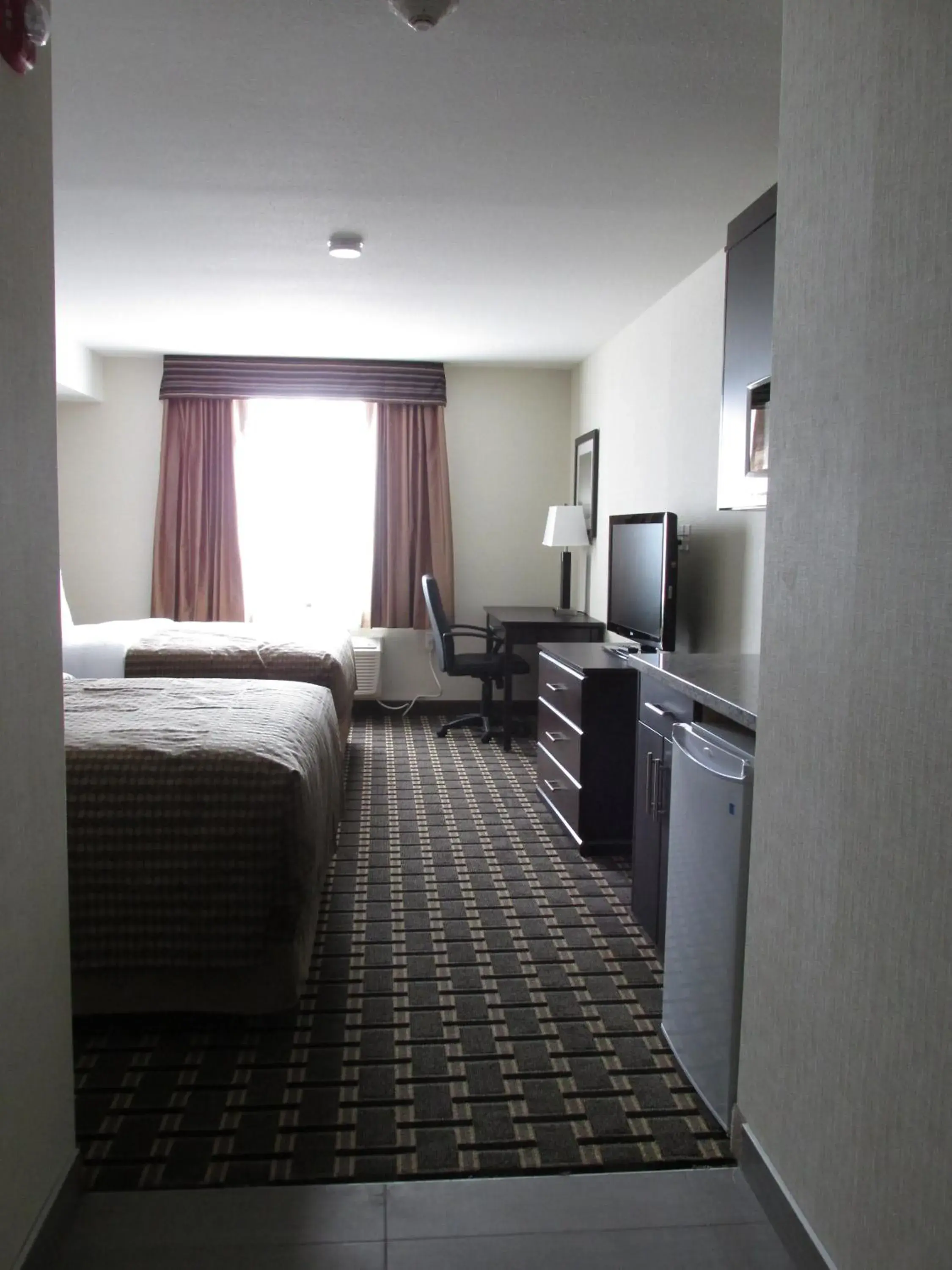 Photo of the whole room, TV/Entertainment Center in Sigma Inn & Suites