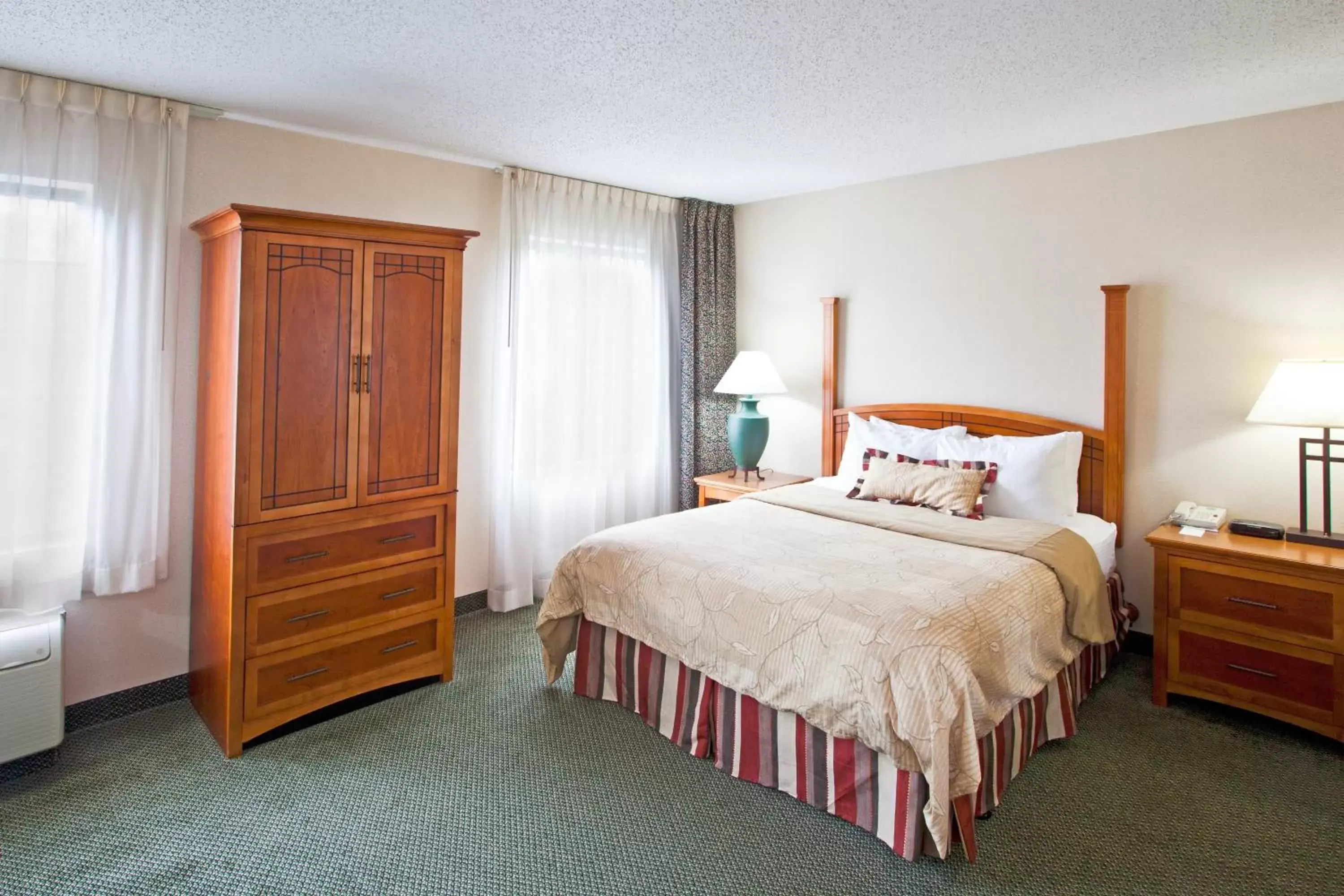Bed in Staybridge Suites Detroit-Utica, an IHG Hotel