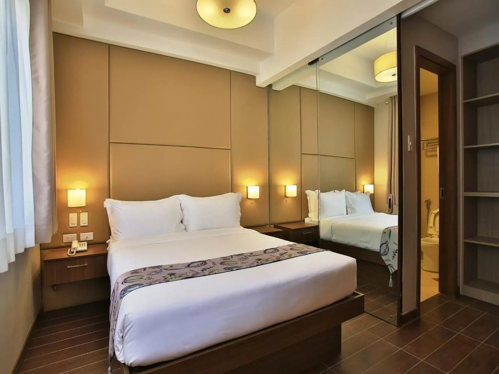 Bed in Valero Grand Suites by Swiss-Belhotel