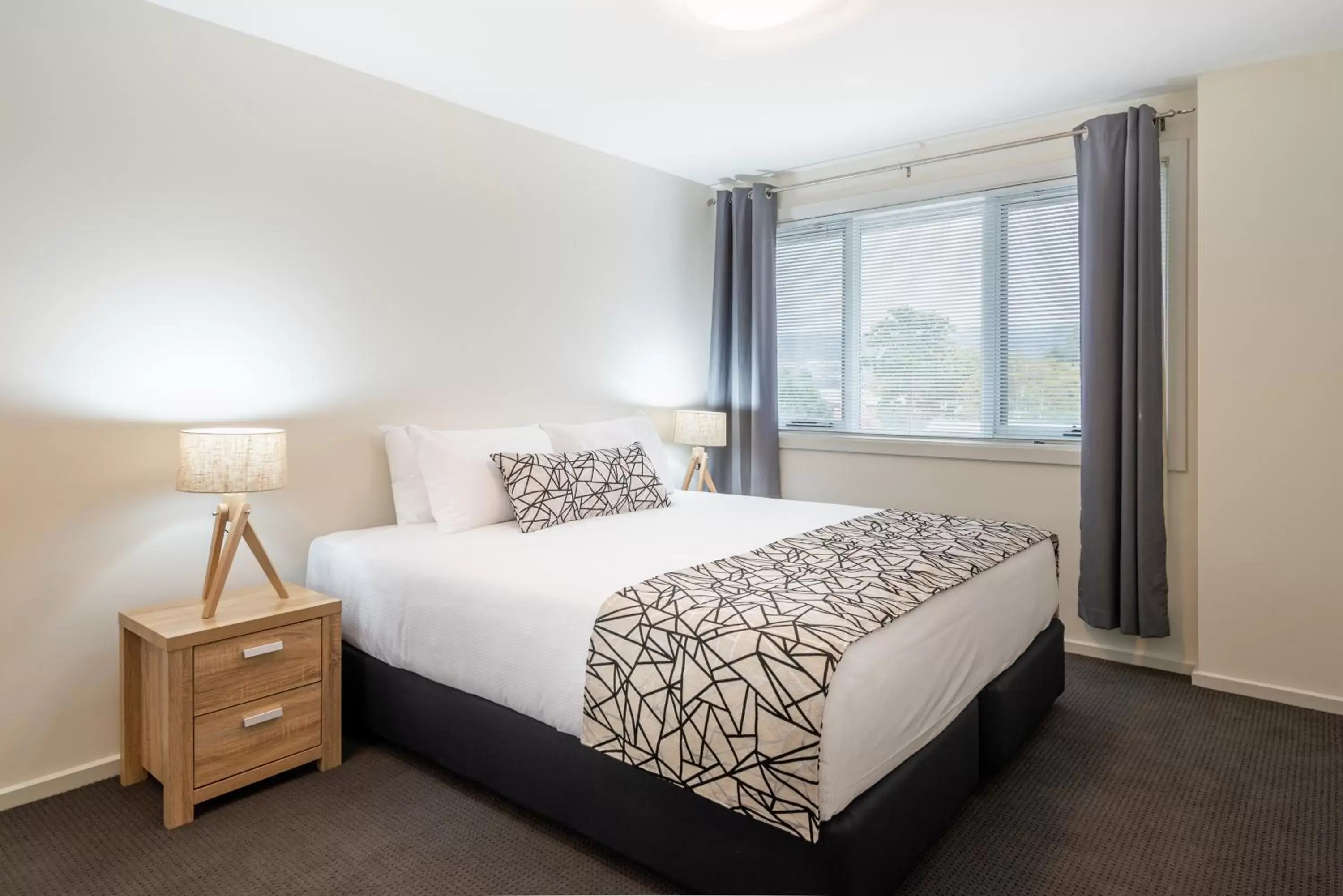 Bed in Warners Bay Apartments