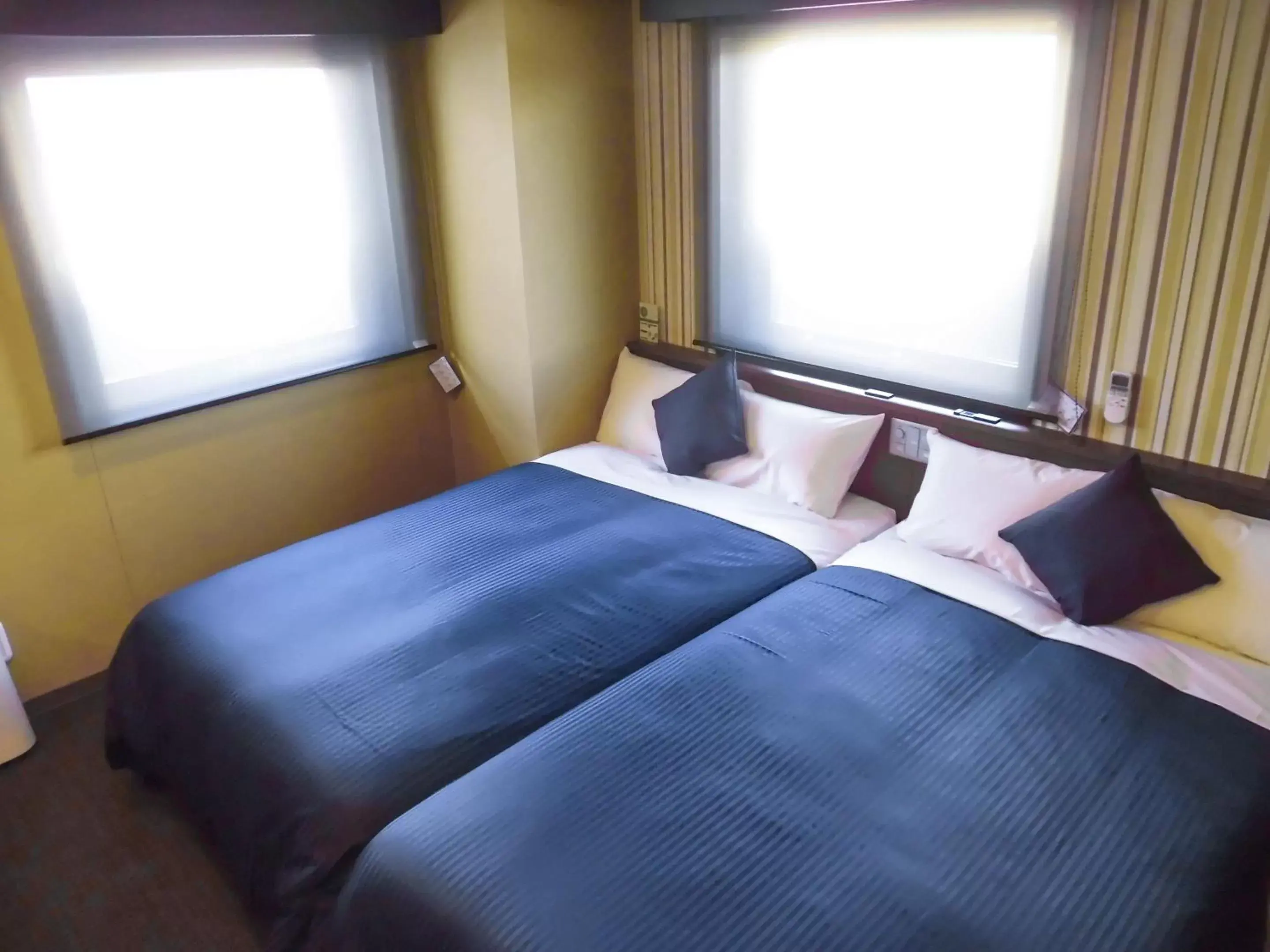 Bed in HOTEL LiVEMAX Fukuyama Ekimae
