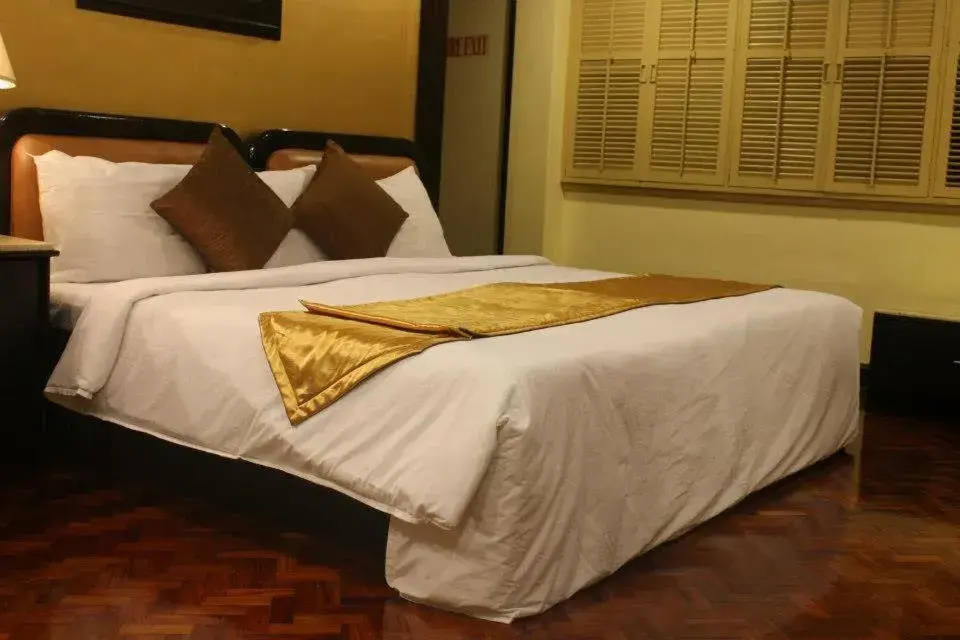 Bed in Lourdes Suites