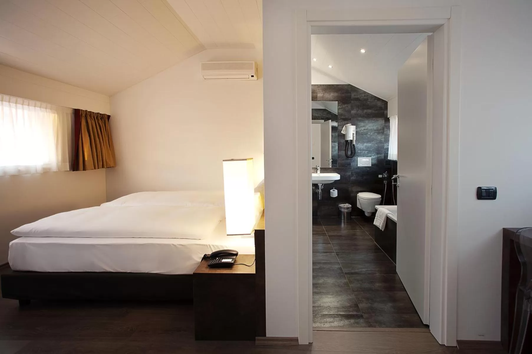 Photo of the whole room, Bed in Hotel Internazionale Bellinzona