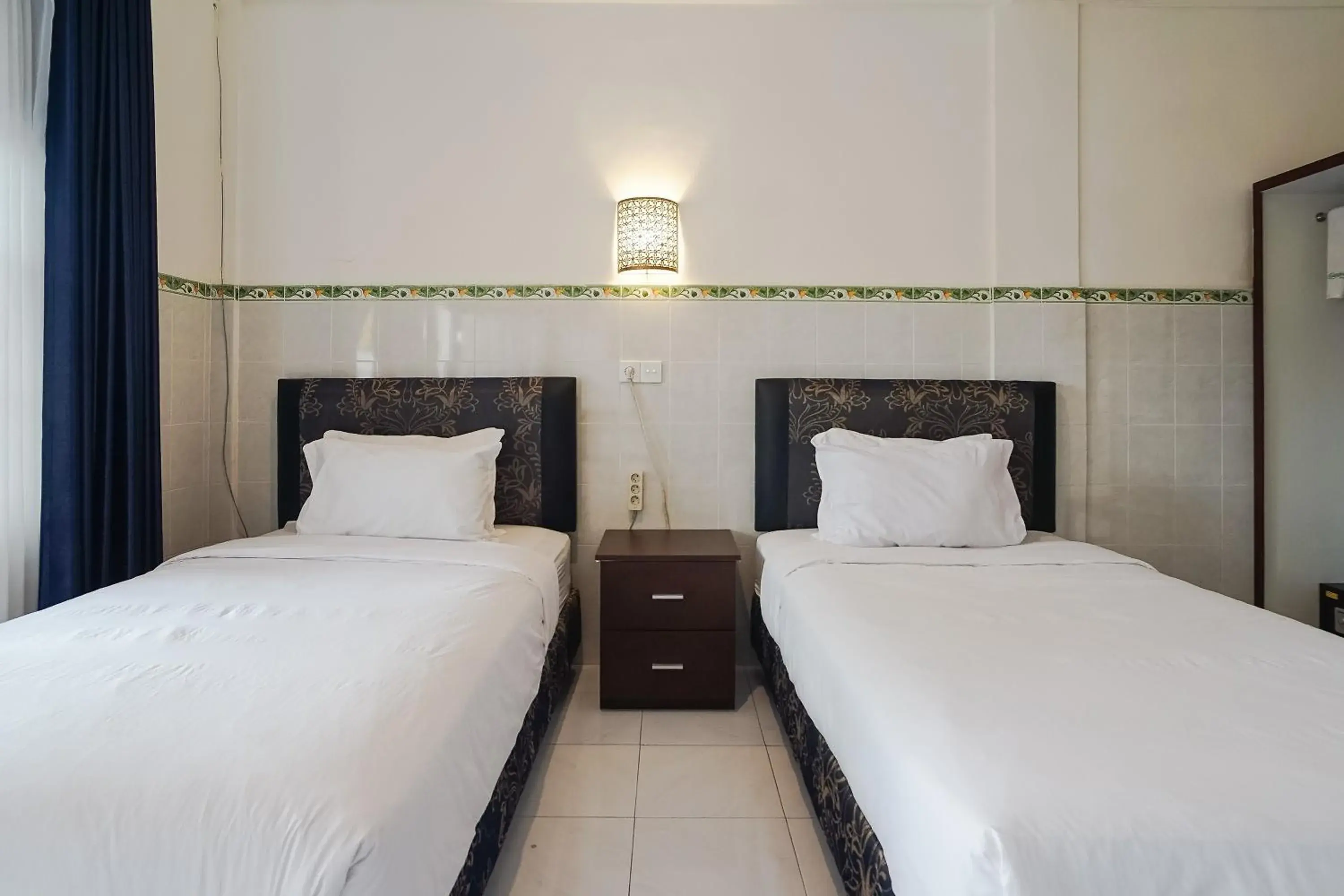 Bed in City Garden Bali Dwipa Hotel