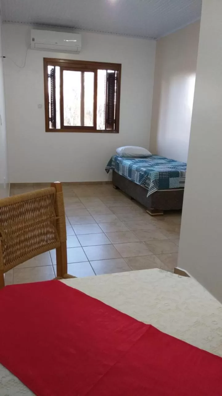 Bed in Hotel Pousada Rolantchê