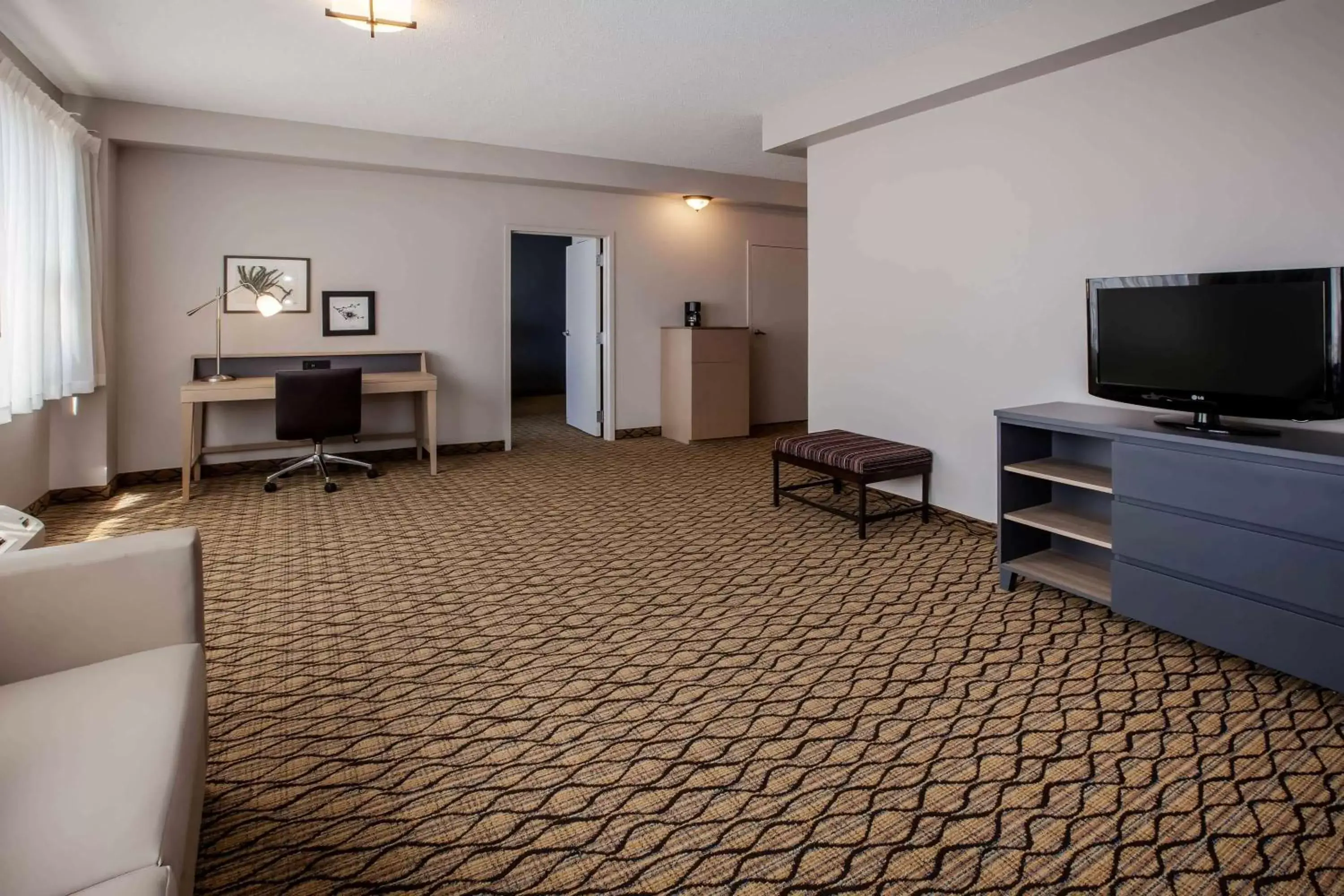 Photo of the whole room, TV/Entertainment Center in Days Inn & Suites by Wyndham Rochester Hills MI