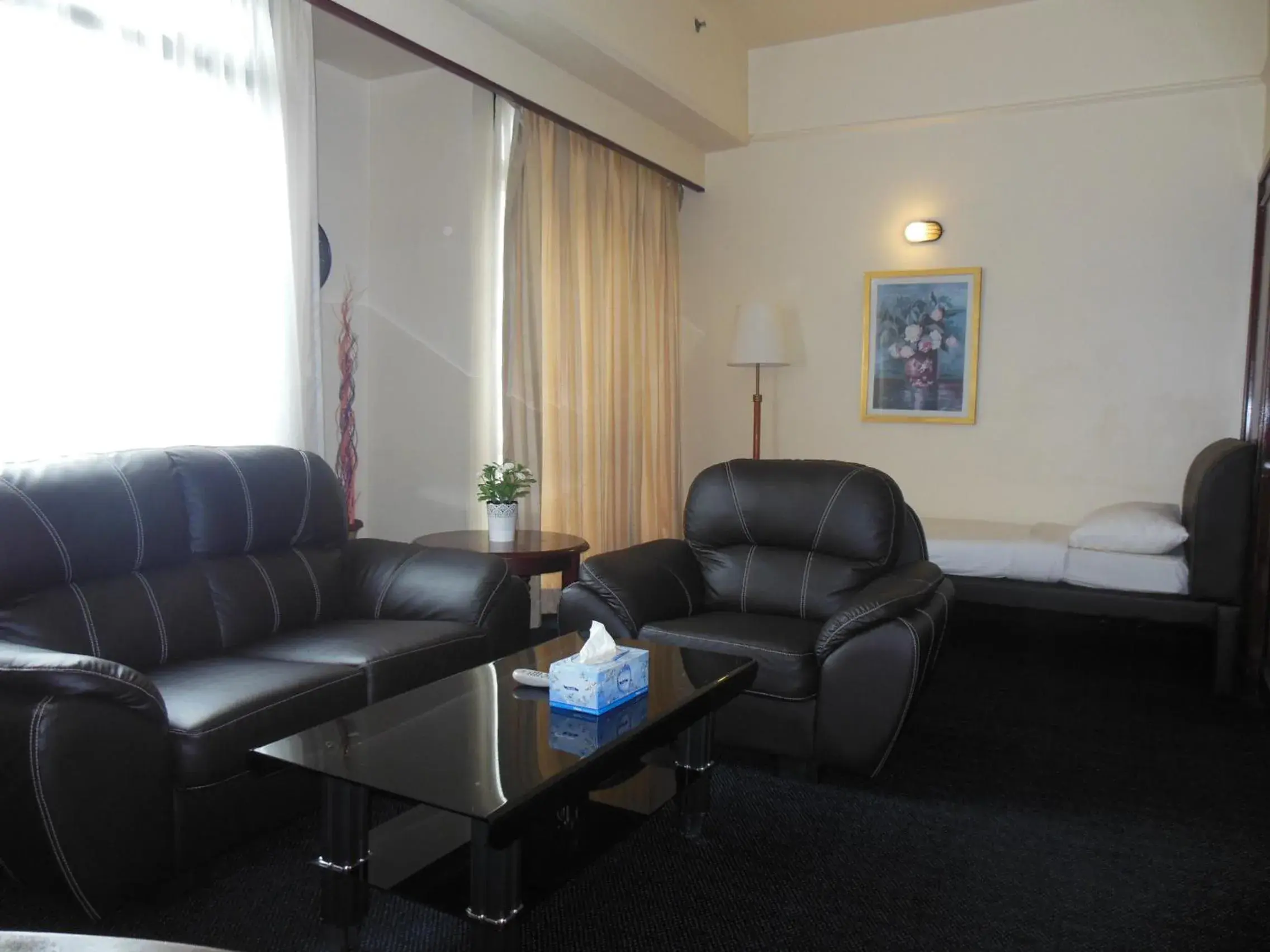 Living room, Seating Area in The Apartments @ Times Square