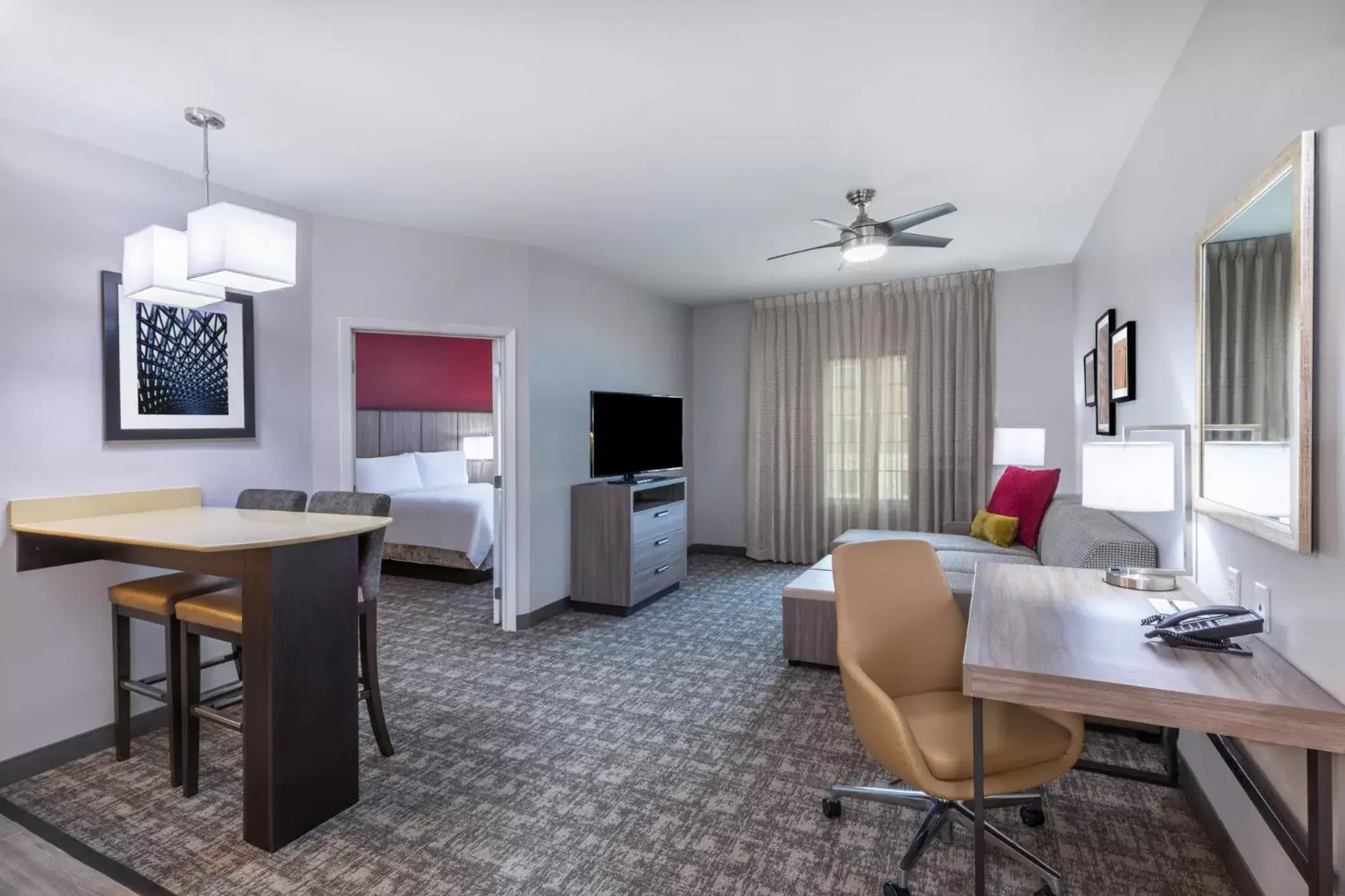 Bed, Seating Area in Staybridge Suites - Houston IAH Airport East, an IHG Hotel