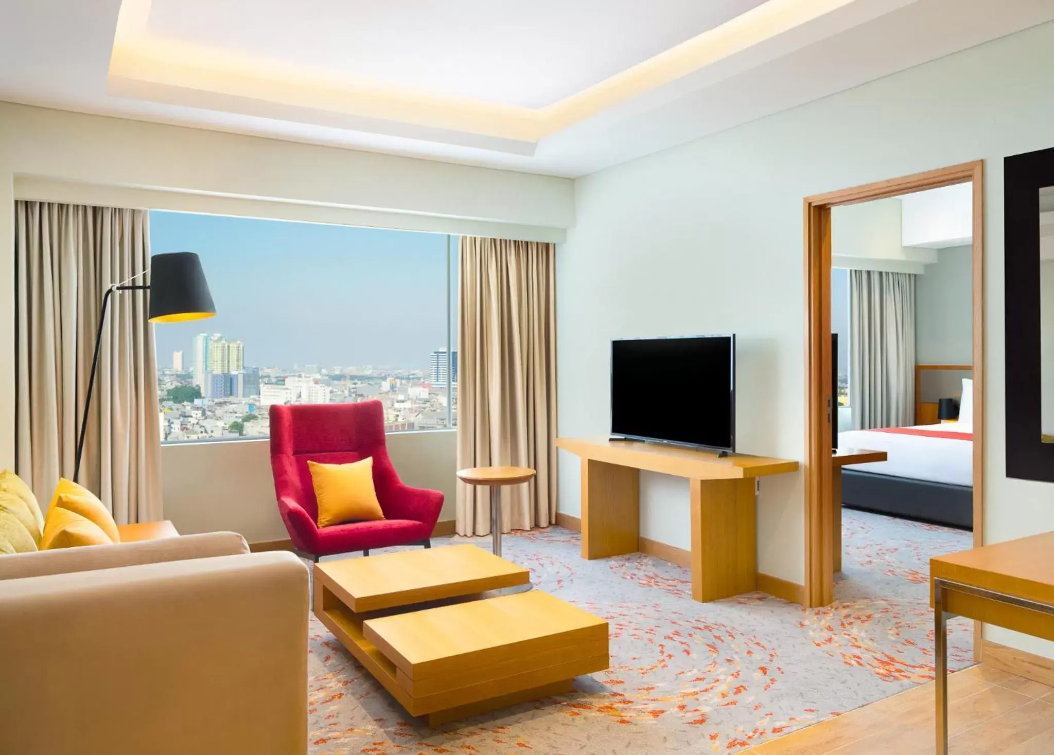 TV and multimedia, Seating Area in Holiday Inn & Suites Jakarta Gajah Mada, an IHG Hotel