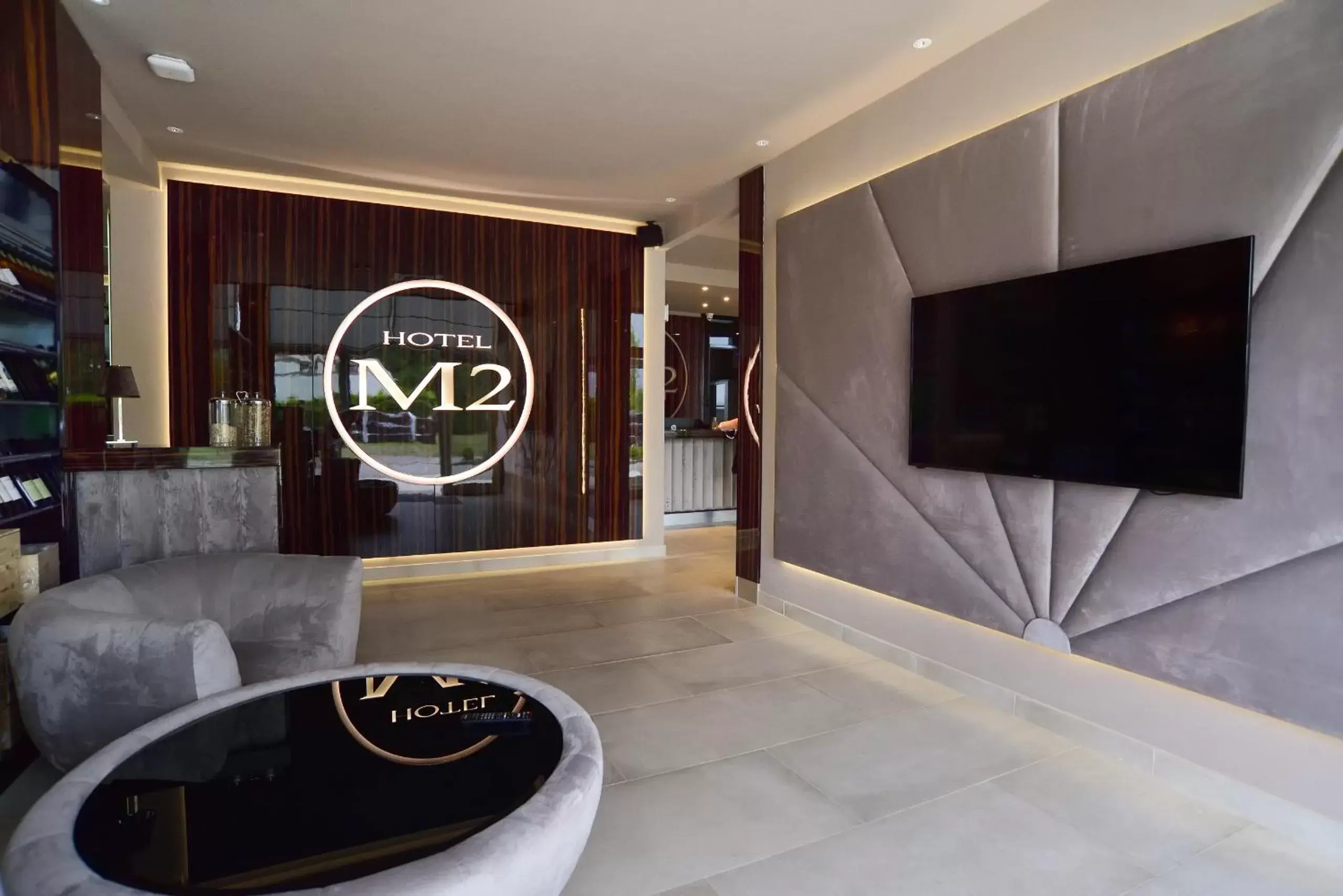 Communal lounge/ TV room, Property Logo/Sign in M2 Hotel
