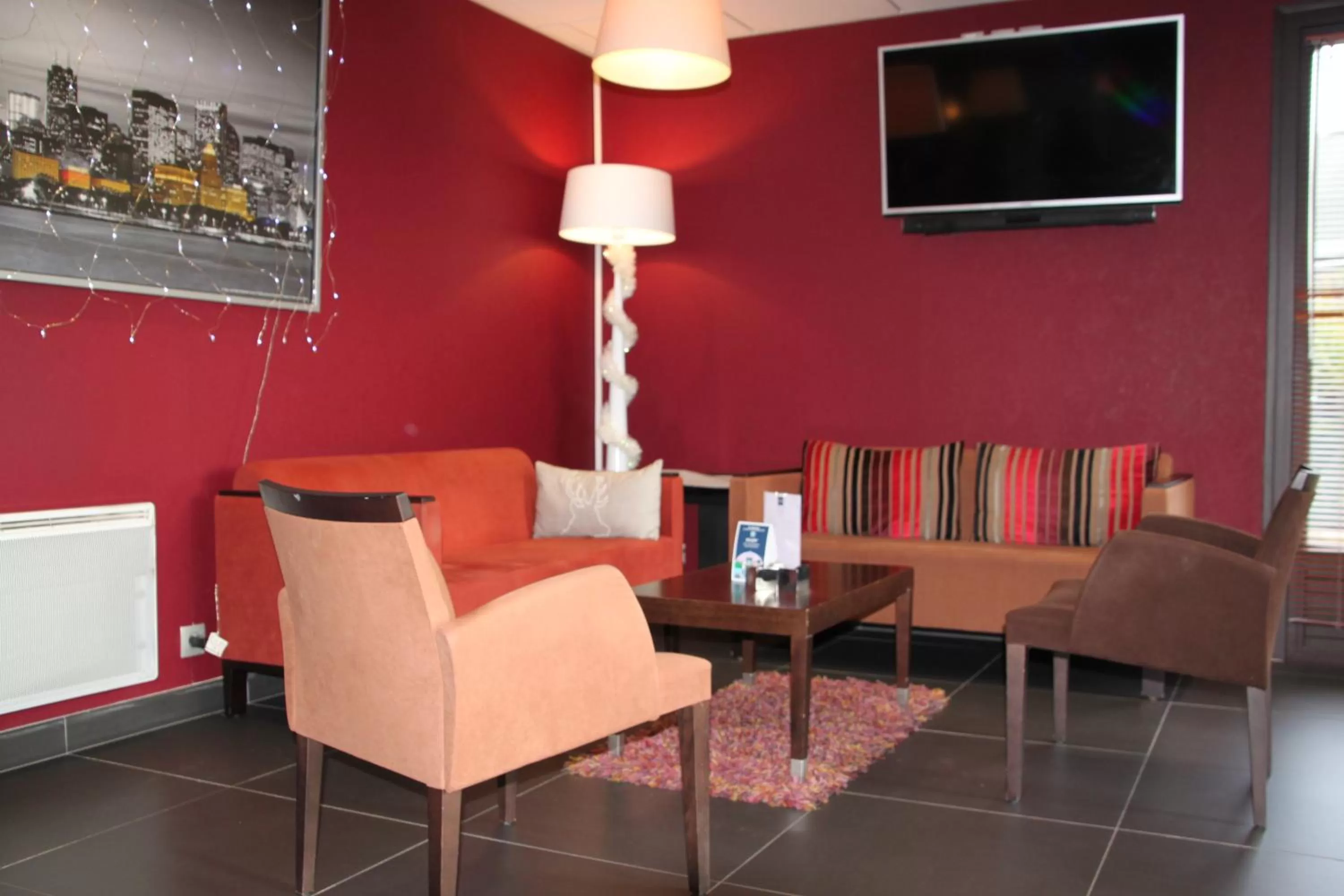 Communal lounge/ TV room in Kyriad Quimper Sud