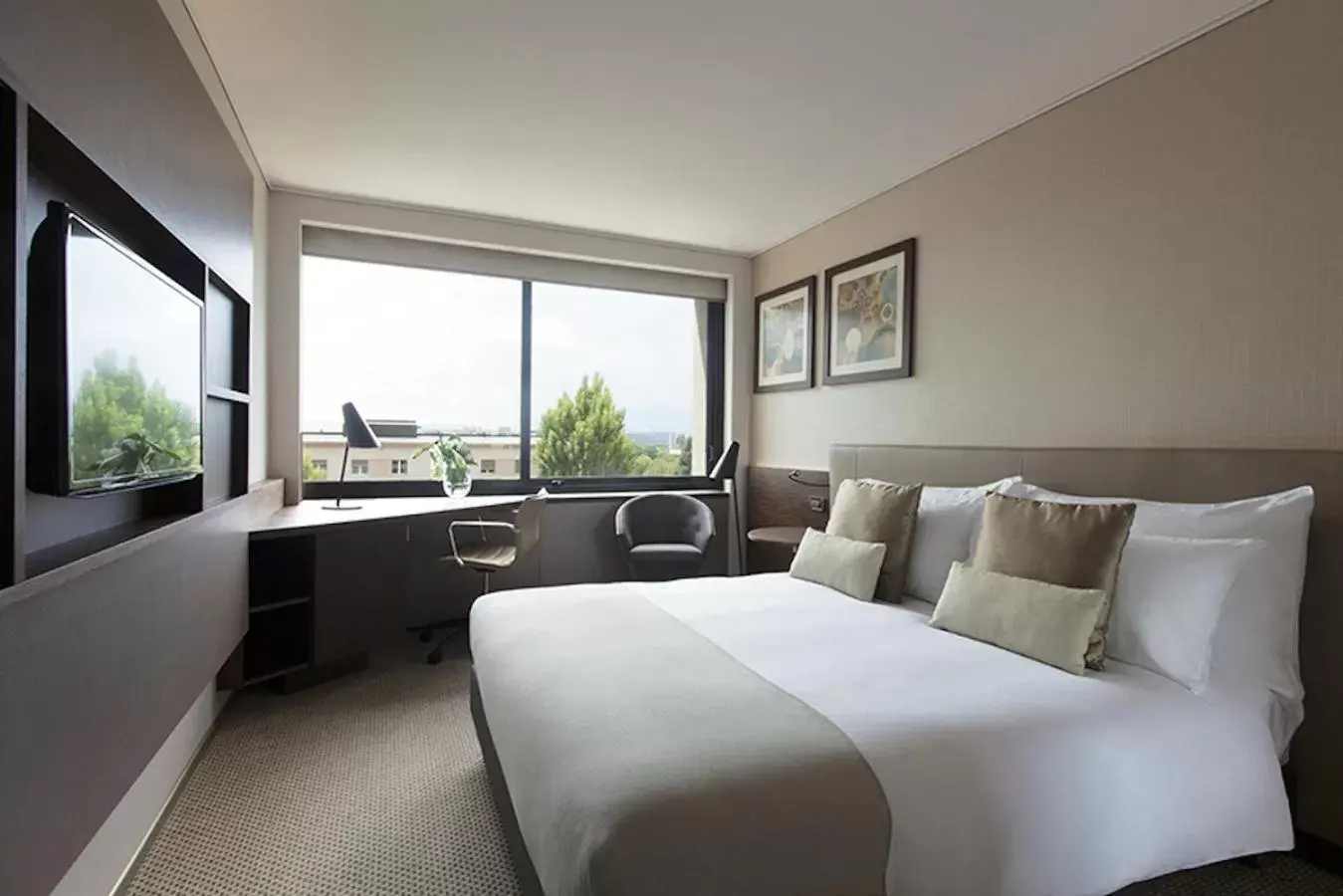 Bed in Crowne Plaza Geneva, an IHG Hotel