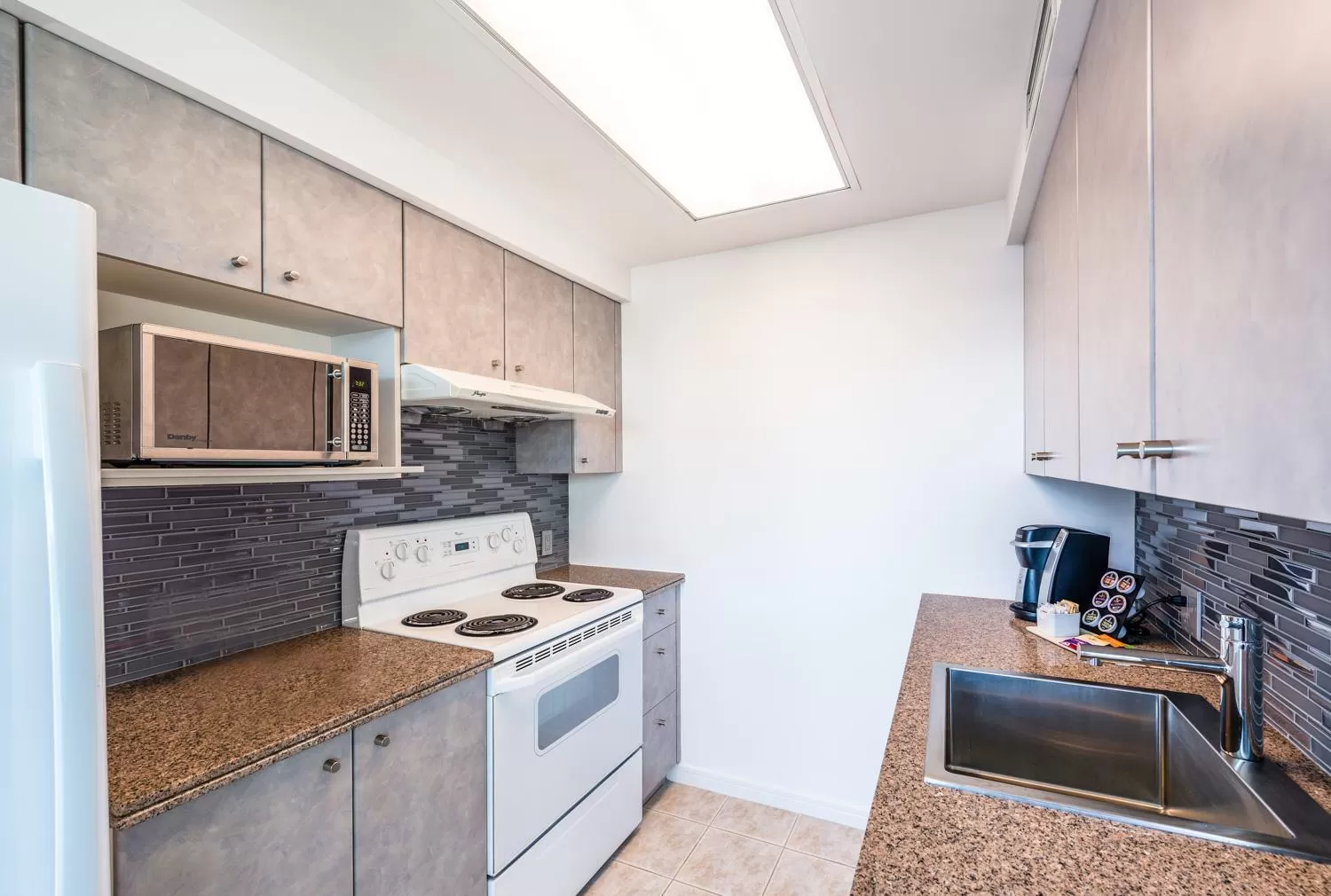 Kitchen or kitchenette in Carmana Hotel & Suites