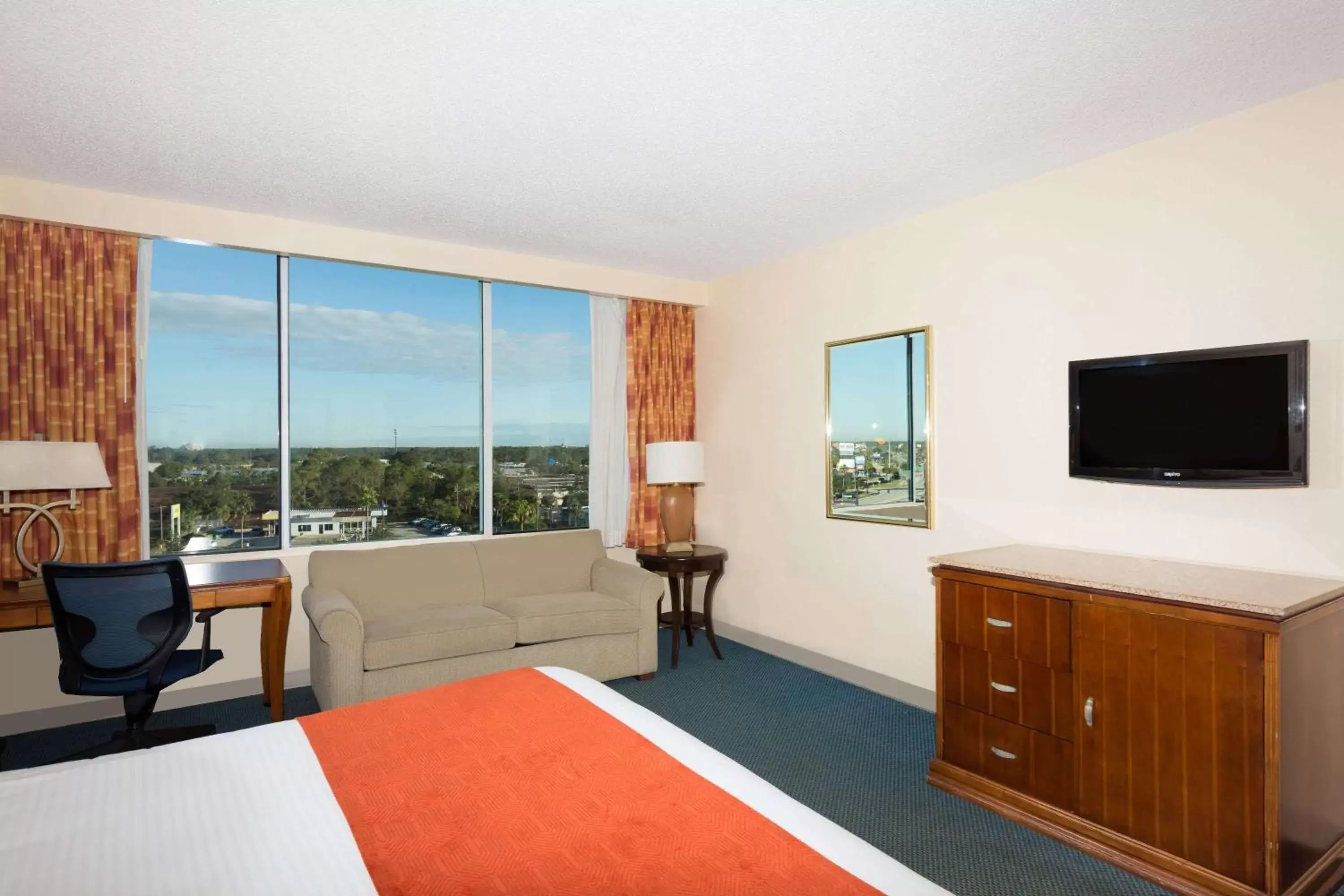 Photo of the whole room, TV/Entertainment Center in Ramada by Wyndham Kissimmee Gateway