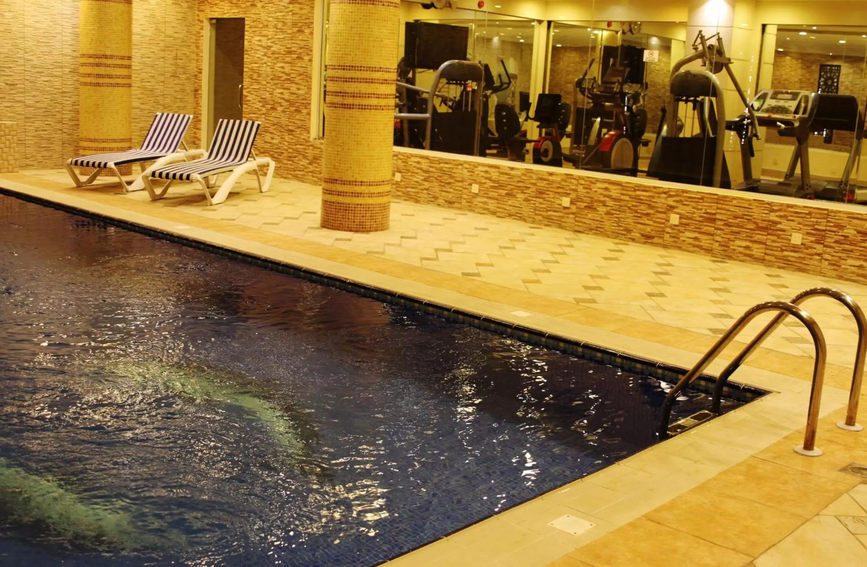 Communal lounge/ TV room, Swimming Pool in Carawan Al Fahad Hotel