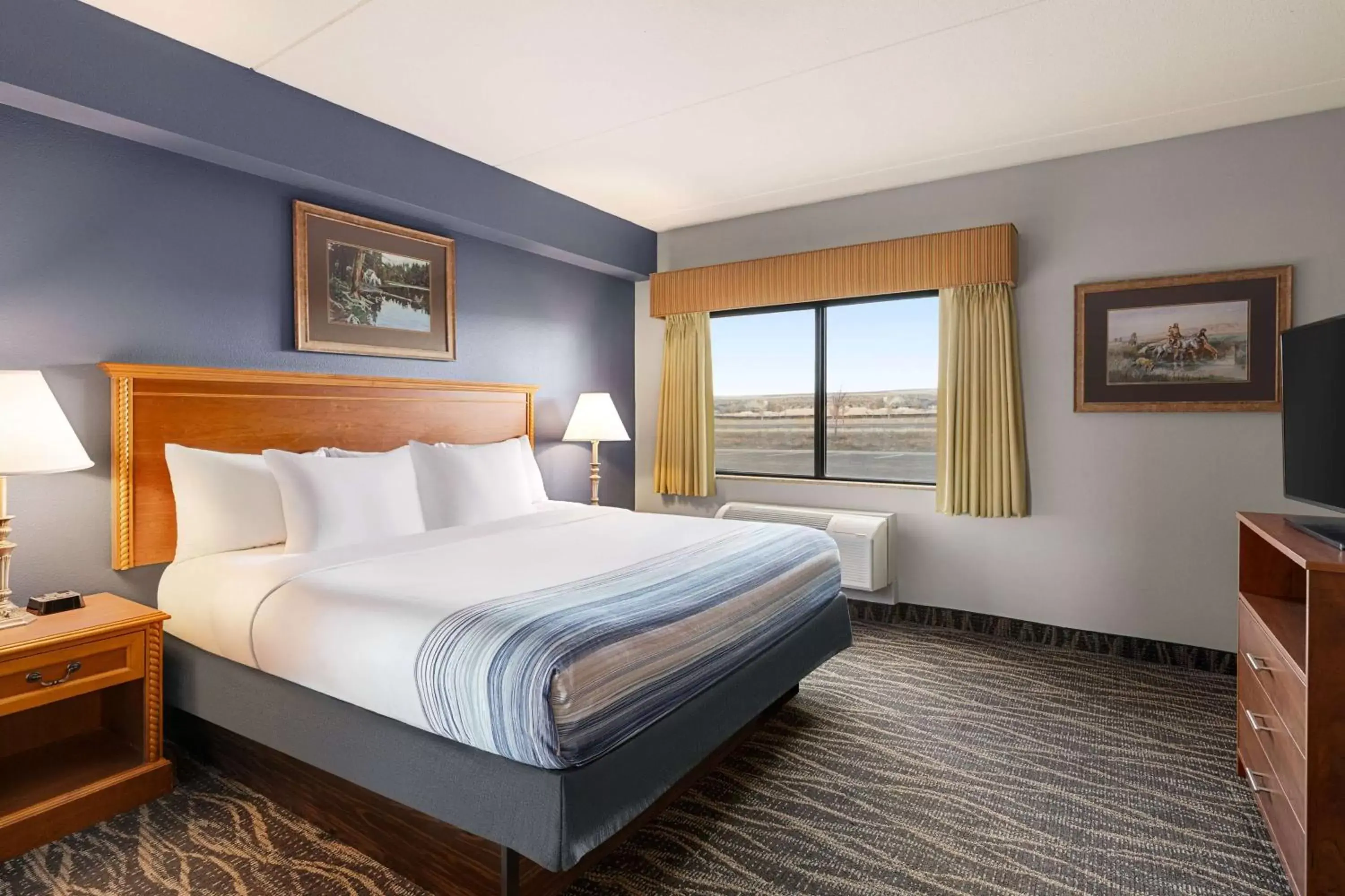 Bed in AmericInn by Wyndham Laramie Near University of Wyoming