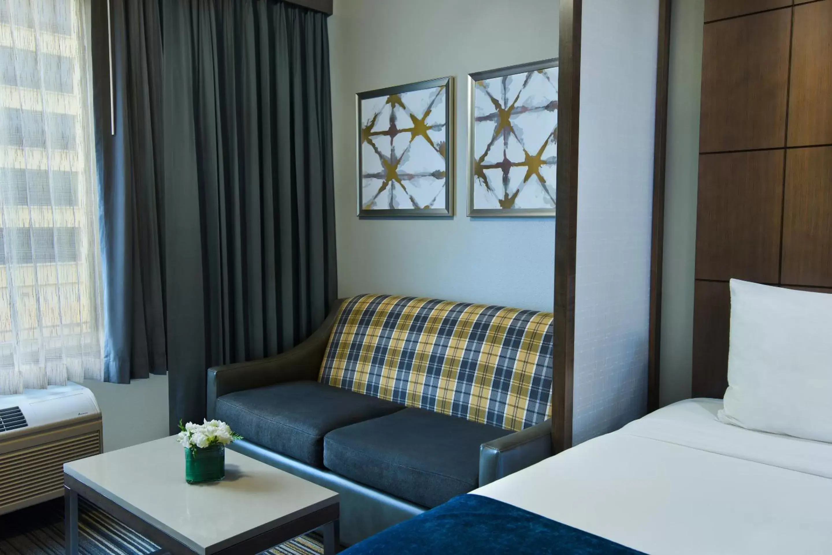 Seating area, Bed in Oxford Suites Spokane Downtown Seating area, Bed in Oxford Suites Spokane Downtown