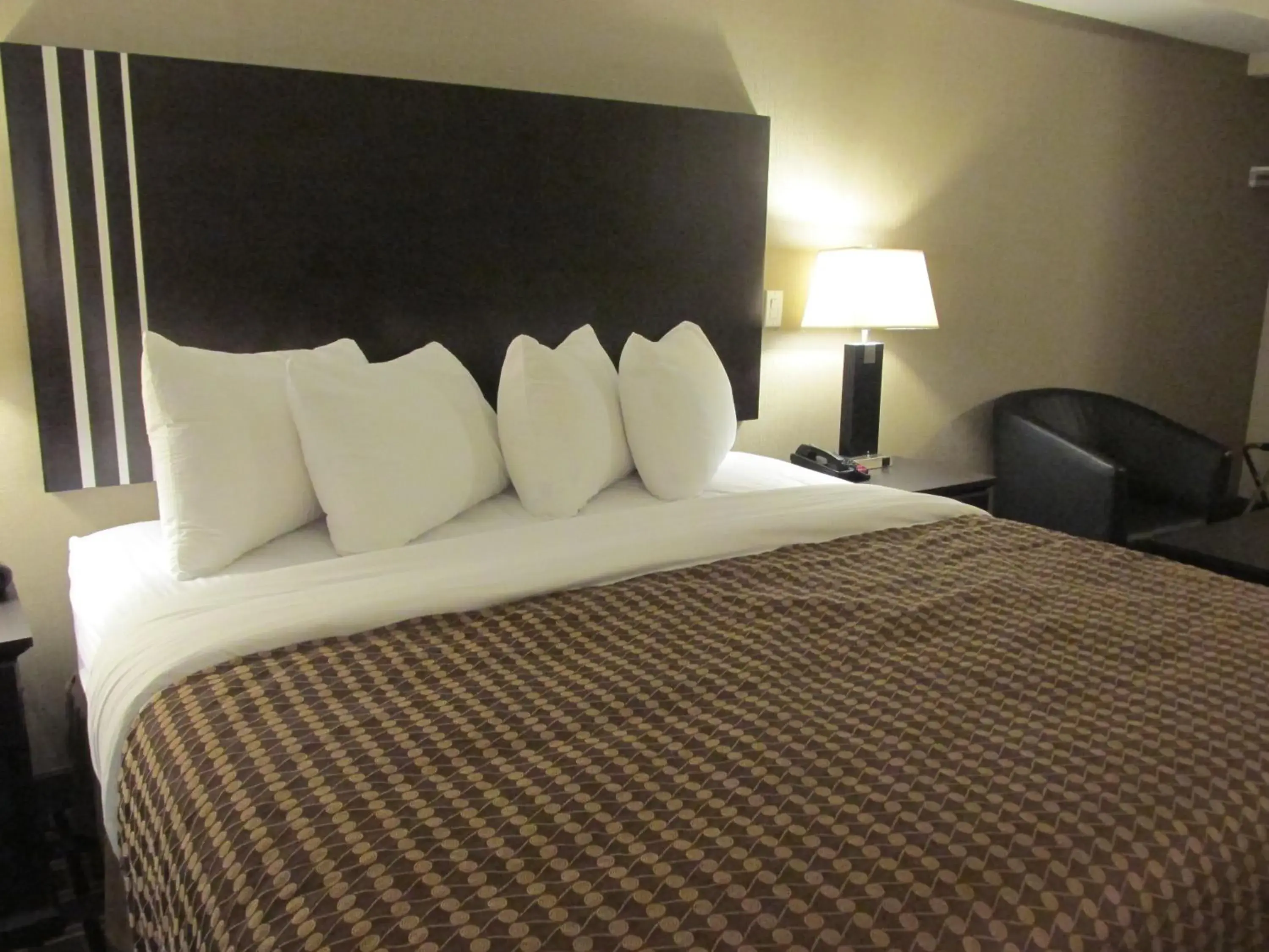 Bed in Sigma Inn & Suites