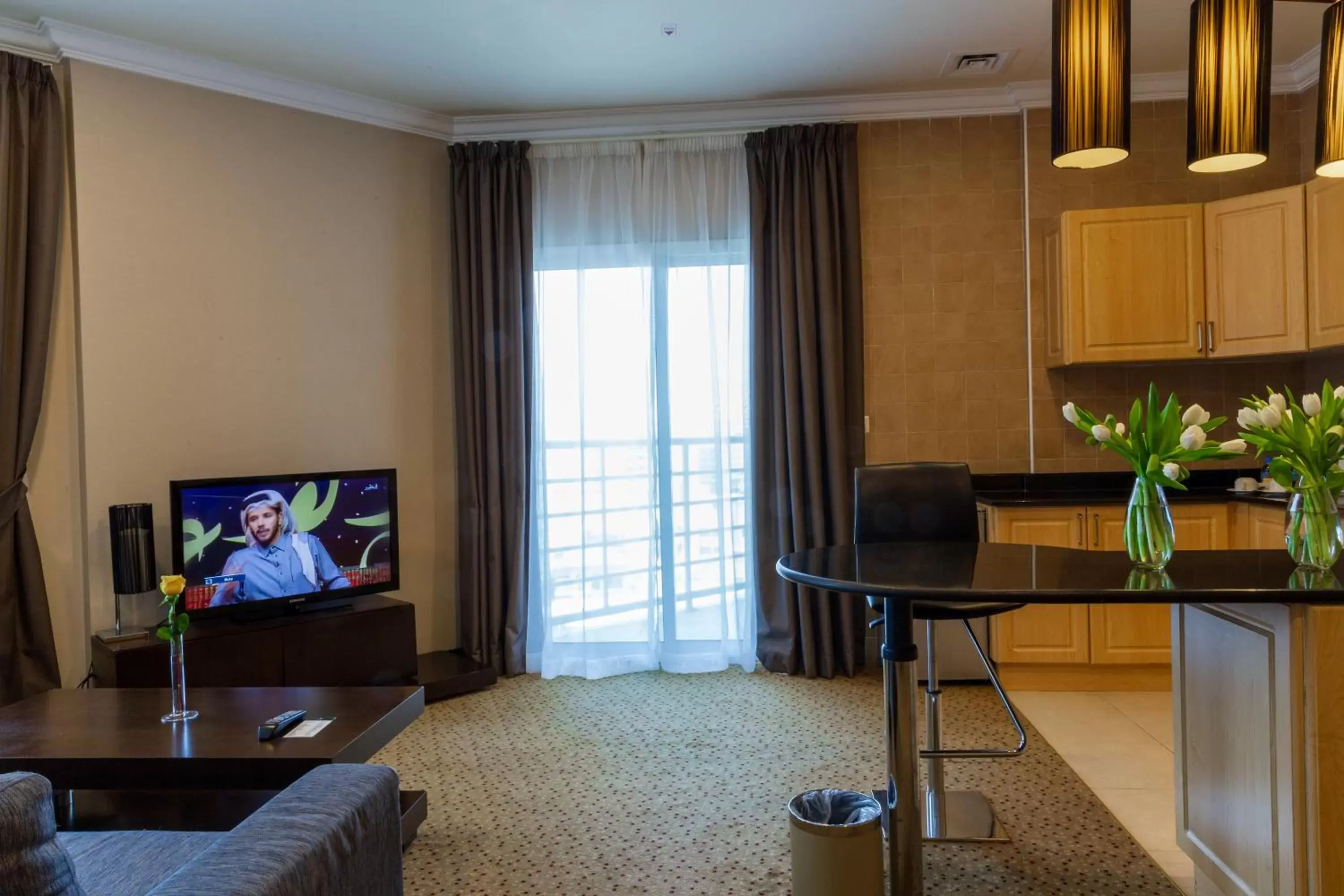 Living room, TV/Entertainment Center in Kingsgate Hotel Doha by Millennium Hotels.