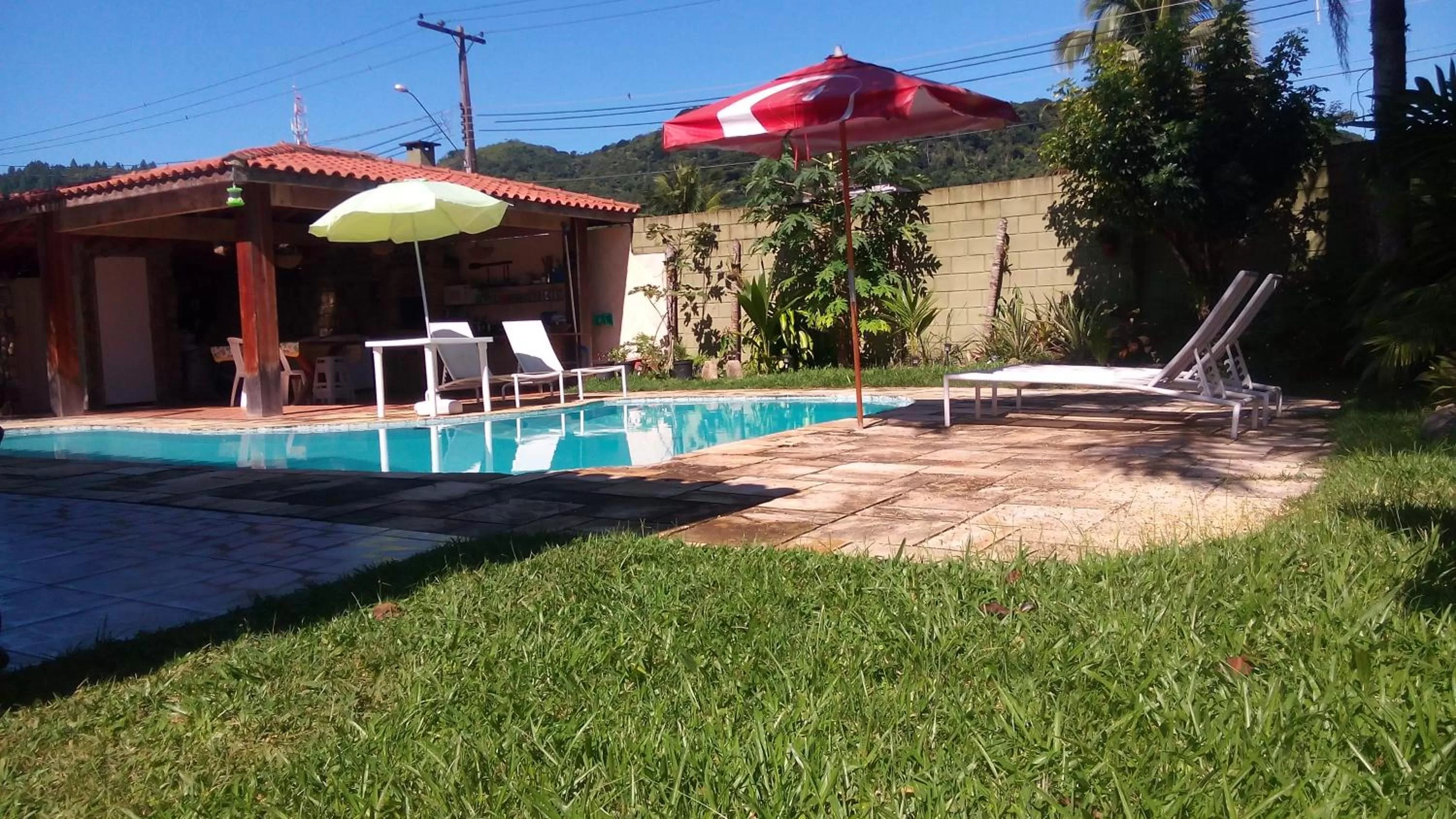Swimming pool in Pousada Na Praia Ubatuba