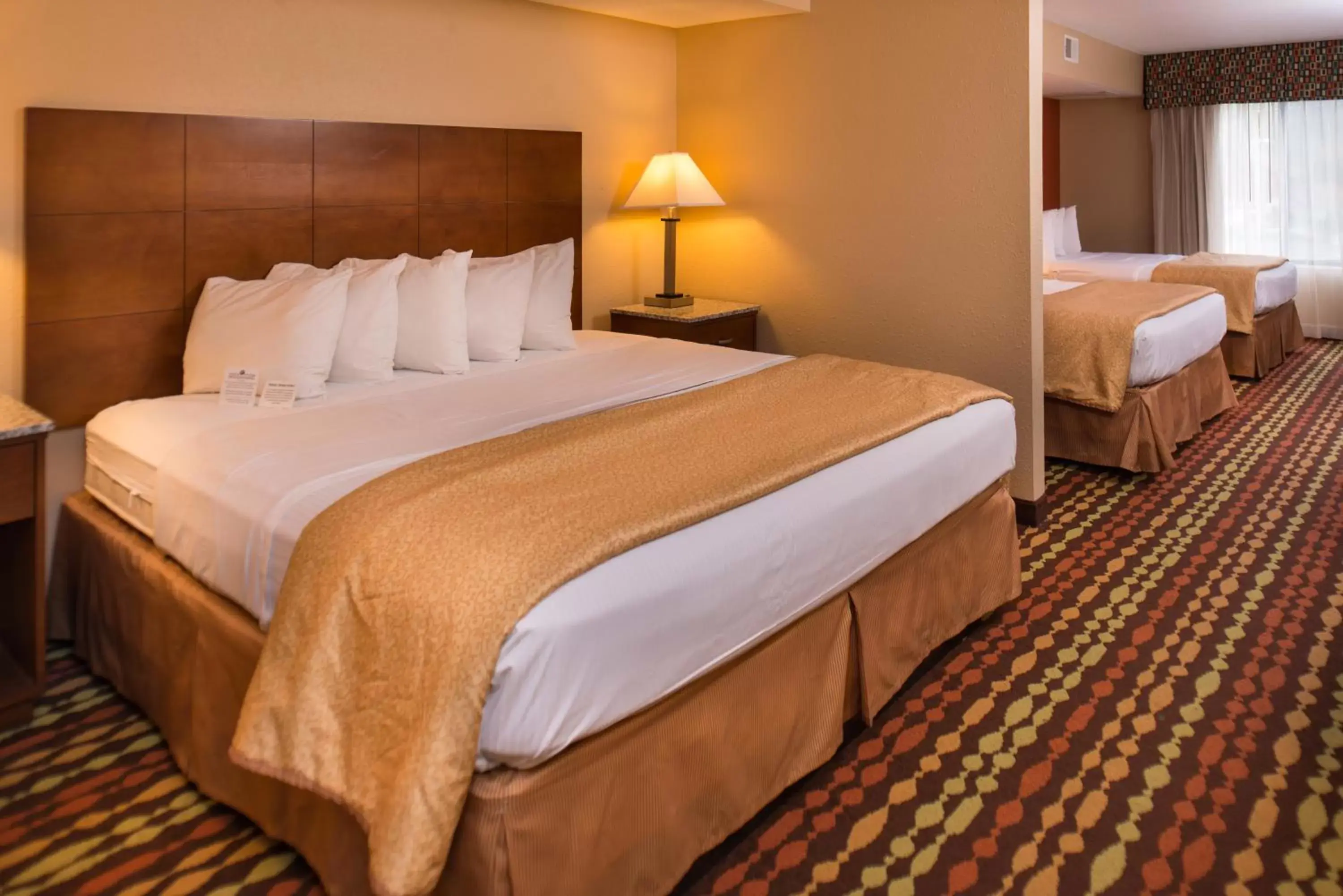 Suite with One King Bed and Two Queen Beds in Best Western Ambassador Inn & Suites