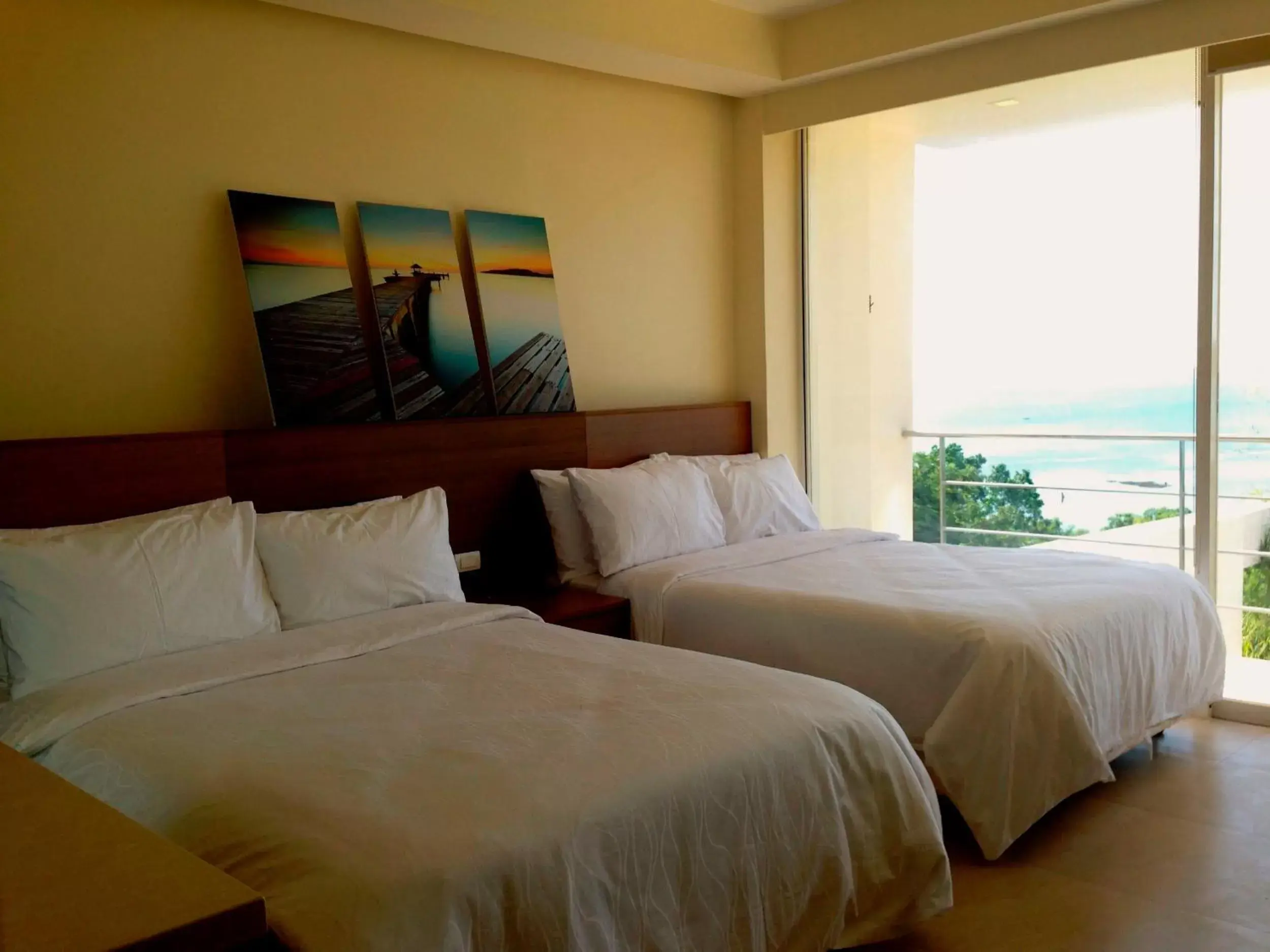 Bed in Ocean Suites Bohol Boutique Hotel