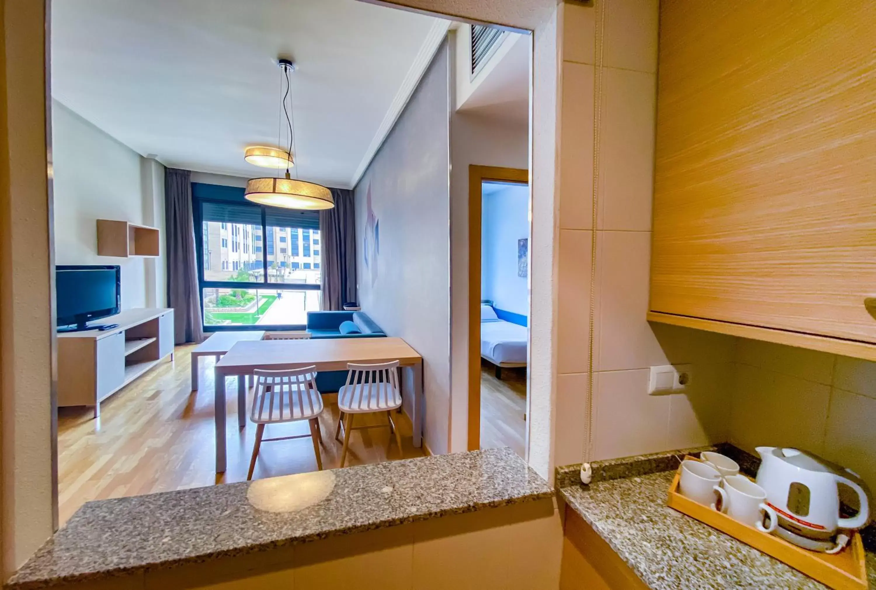 Bed, Kitchen/Kitchenette in Compostela Suites