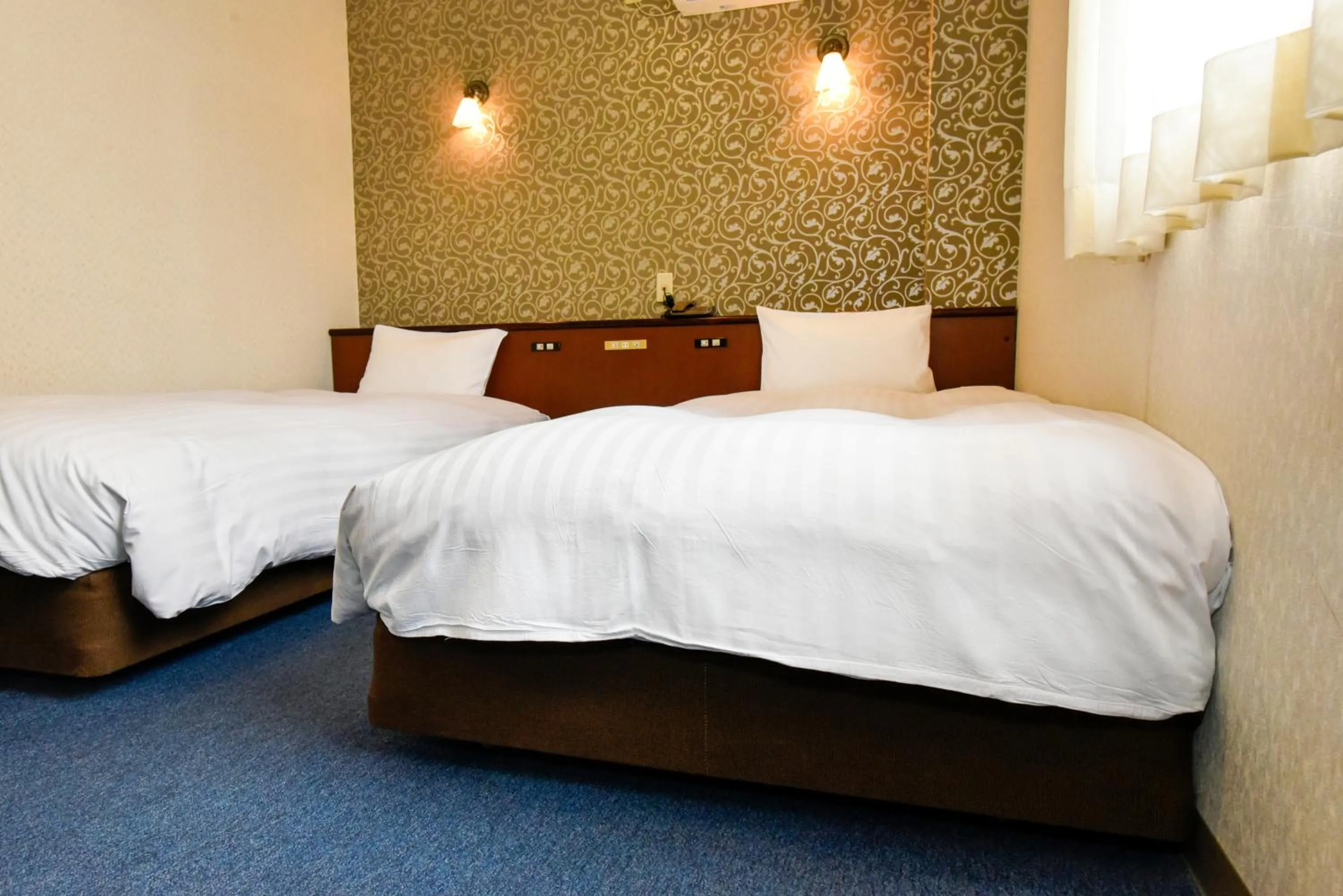 Bed in Hotel Palms Tenmonkan