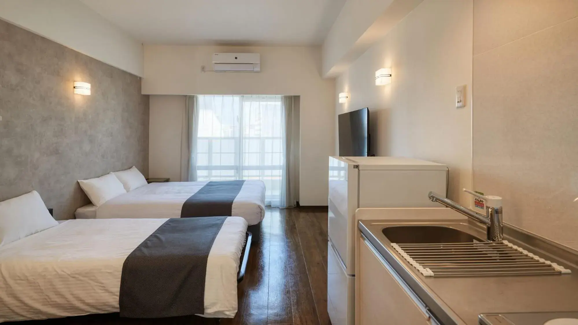 Photo of the whole room, Bed in New Normal Hotel in NAMINOUE ニューノーマルホテルイン波の上 Photo of the whole room, Bed in New Normal Hotel in NAMINOUE ニューノーマルホテルイン波の上