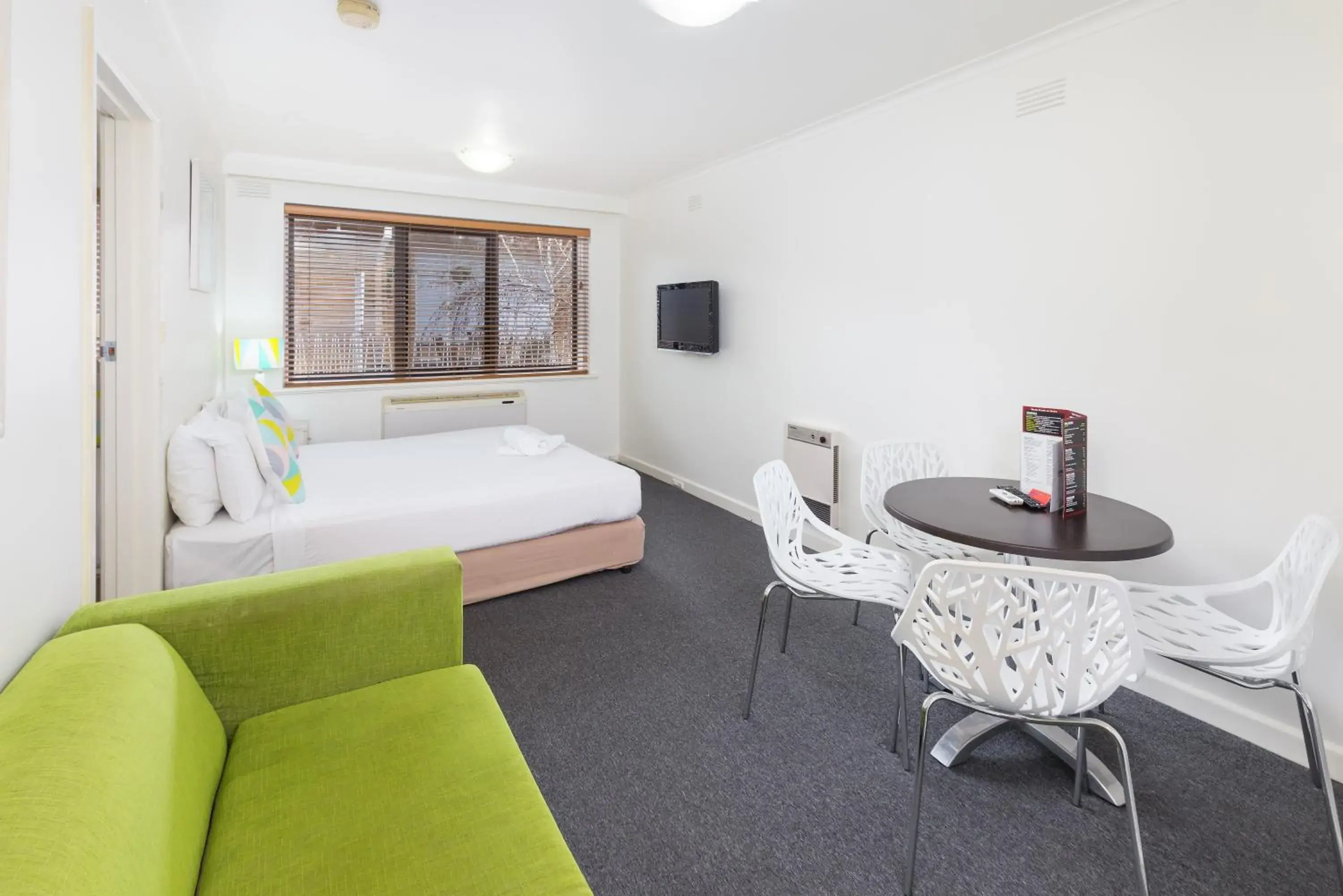 Seating area in City Edge East Melbourne Apartment Hotel