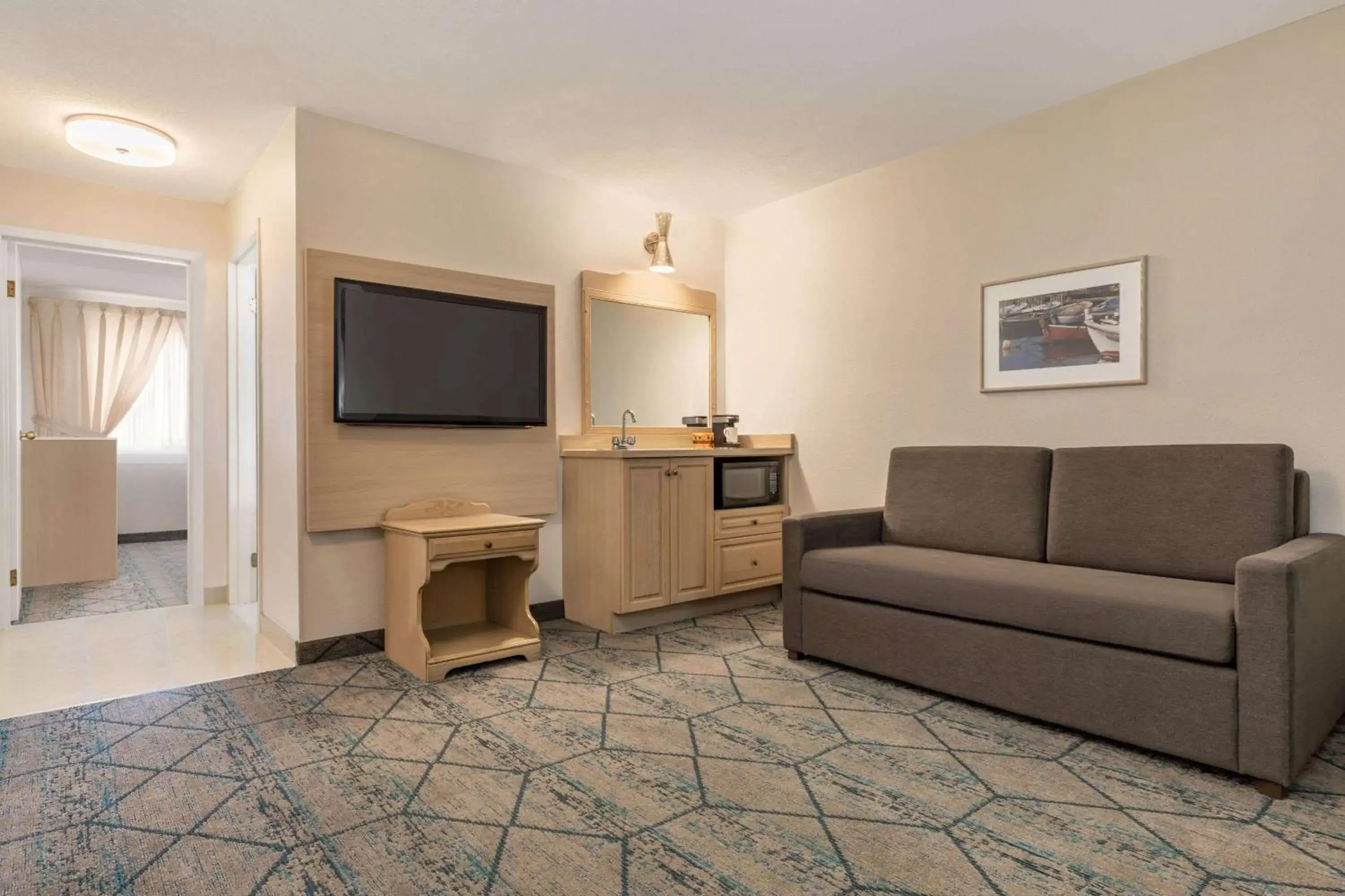 Living room, TV/Entertainment Center in Ramada by Wyndham Miramichi New Brunswick