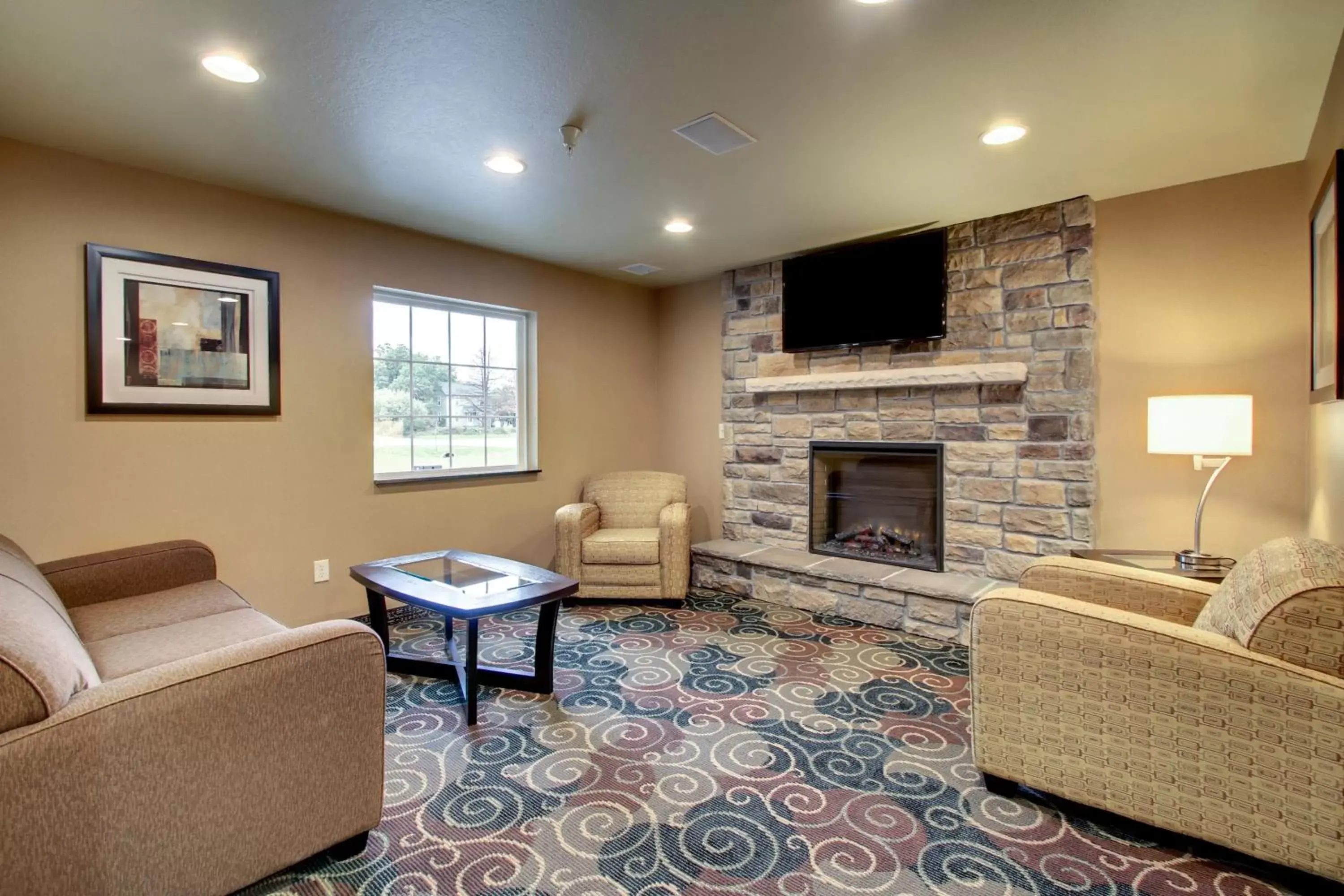 Communal lounge/ TV room, Seating Area in Cobblestone Inn & Suites - Schuyler