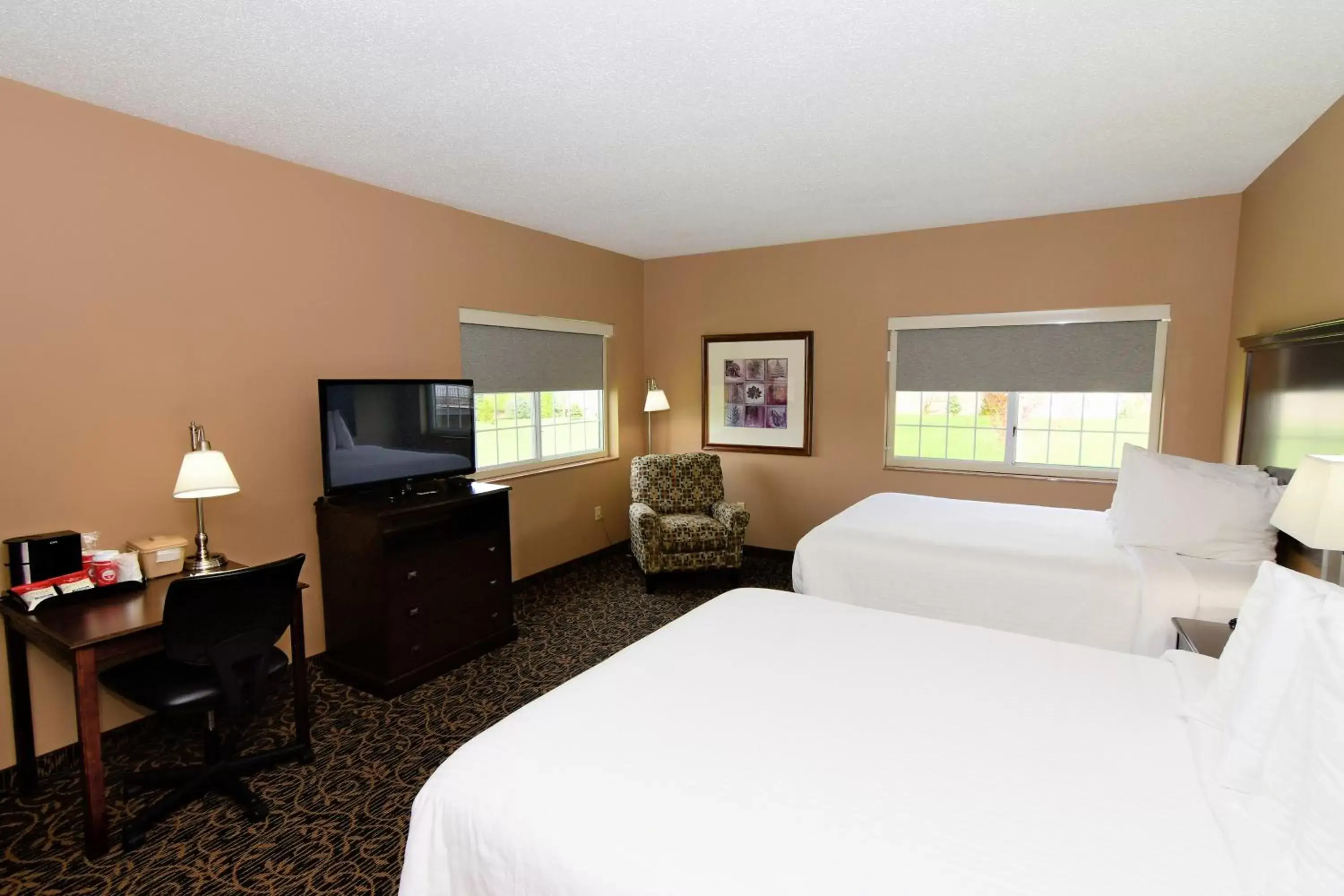 Bed in Cobblestone Inn & Suites - Denison | Majestic Hills