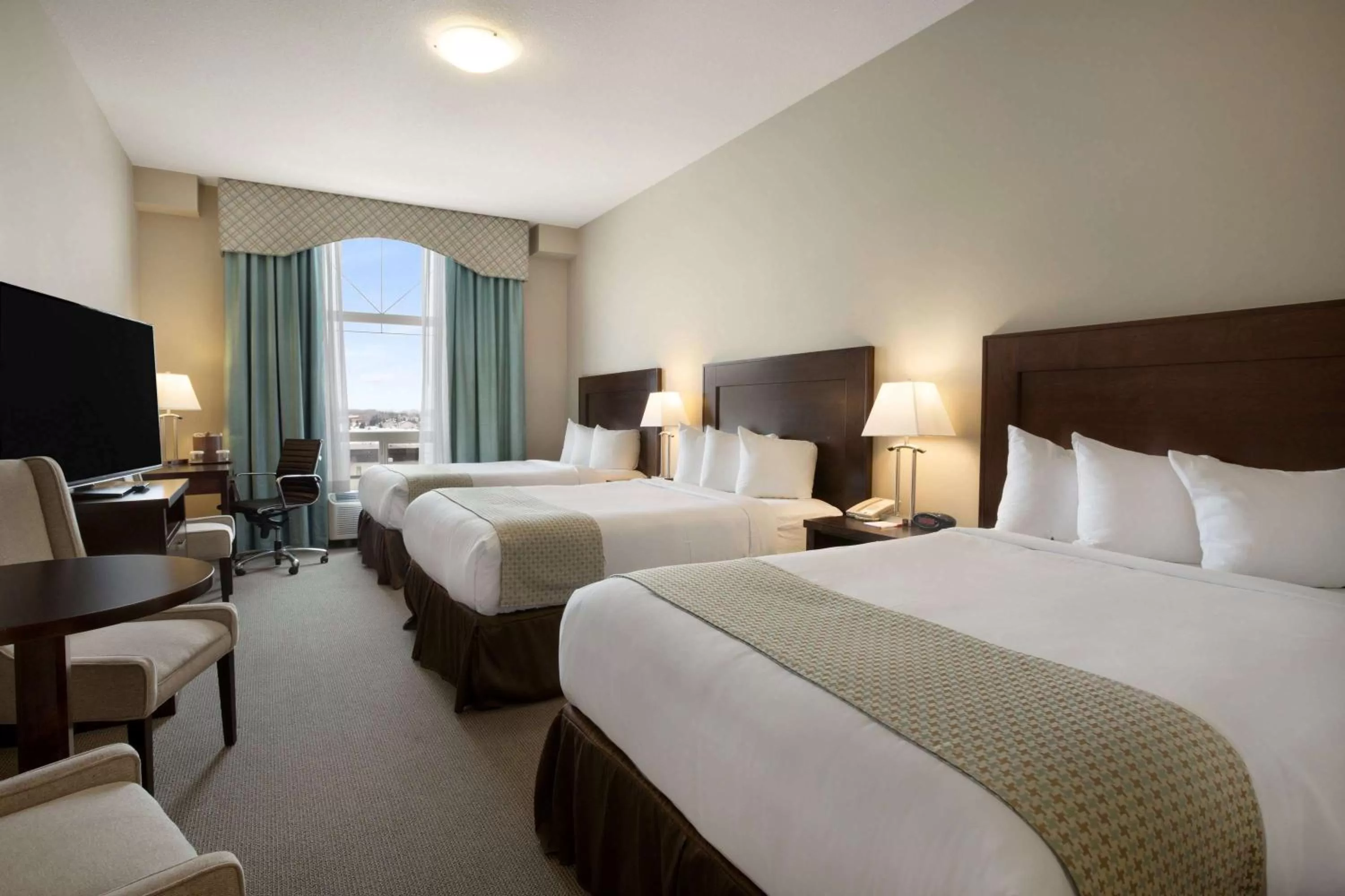 Photo of the whole room, Bed in Ramada by Wyndham Emerald Park/Regina East