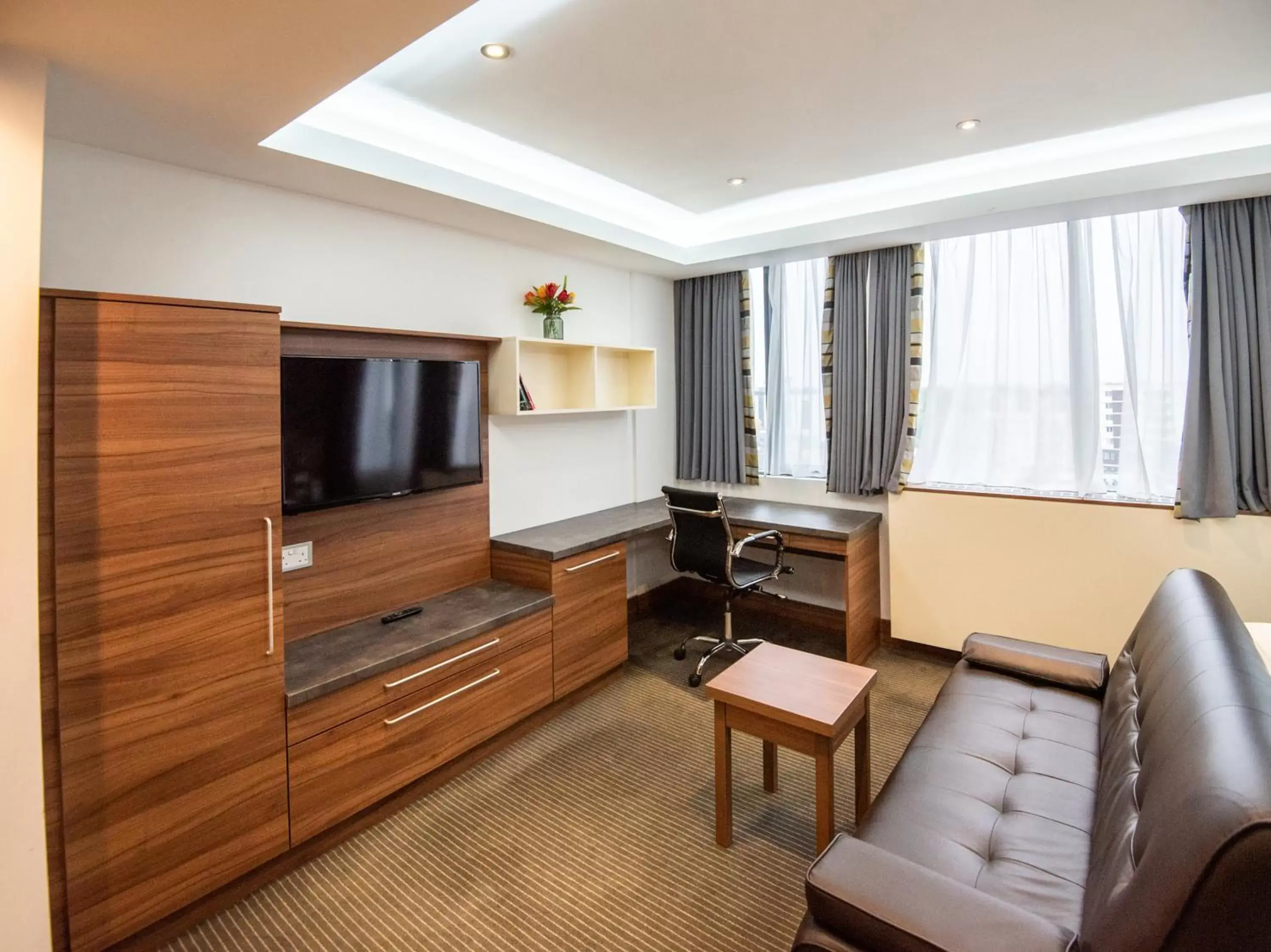 Living room, TV/Entertainment Center in Livin' Serviced Apartments