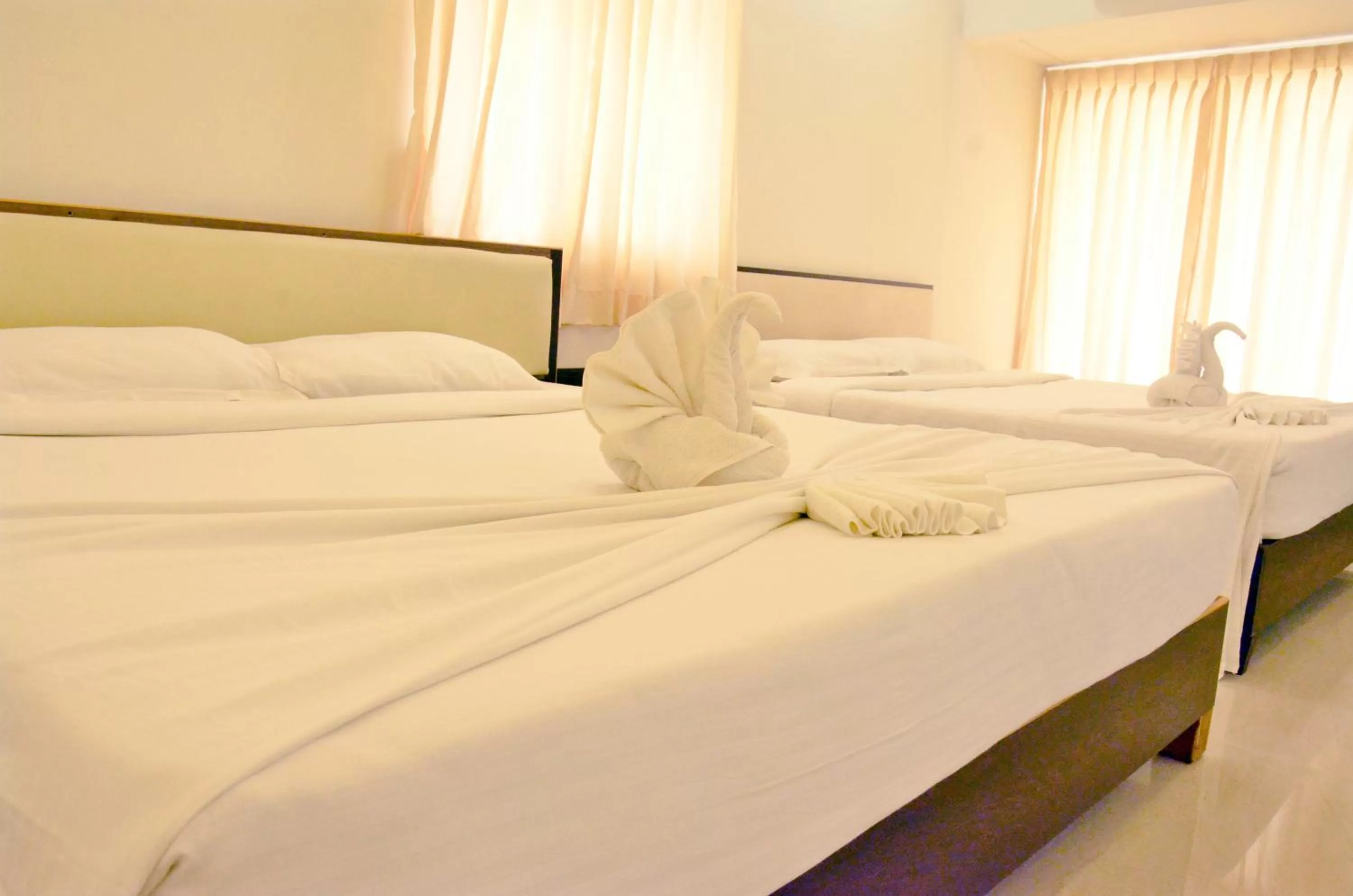 Bed in Hotel Ambai Grand