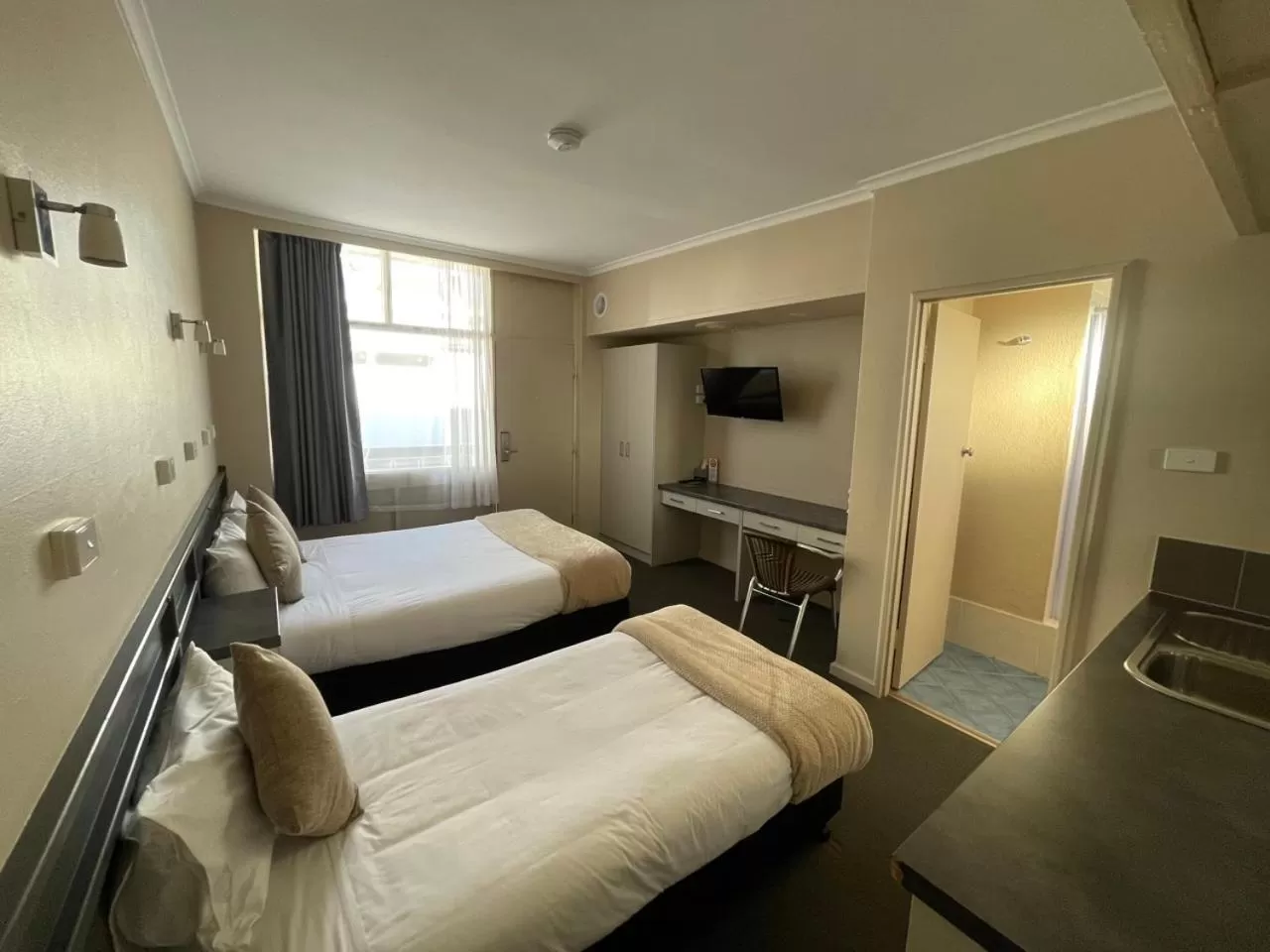 Bed in Astor Hotel Motel